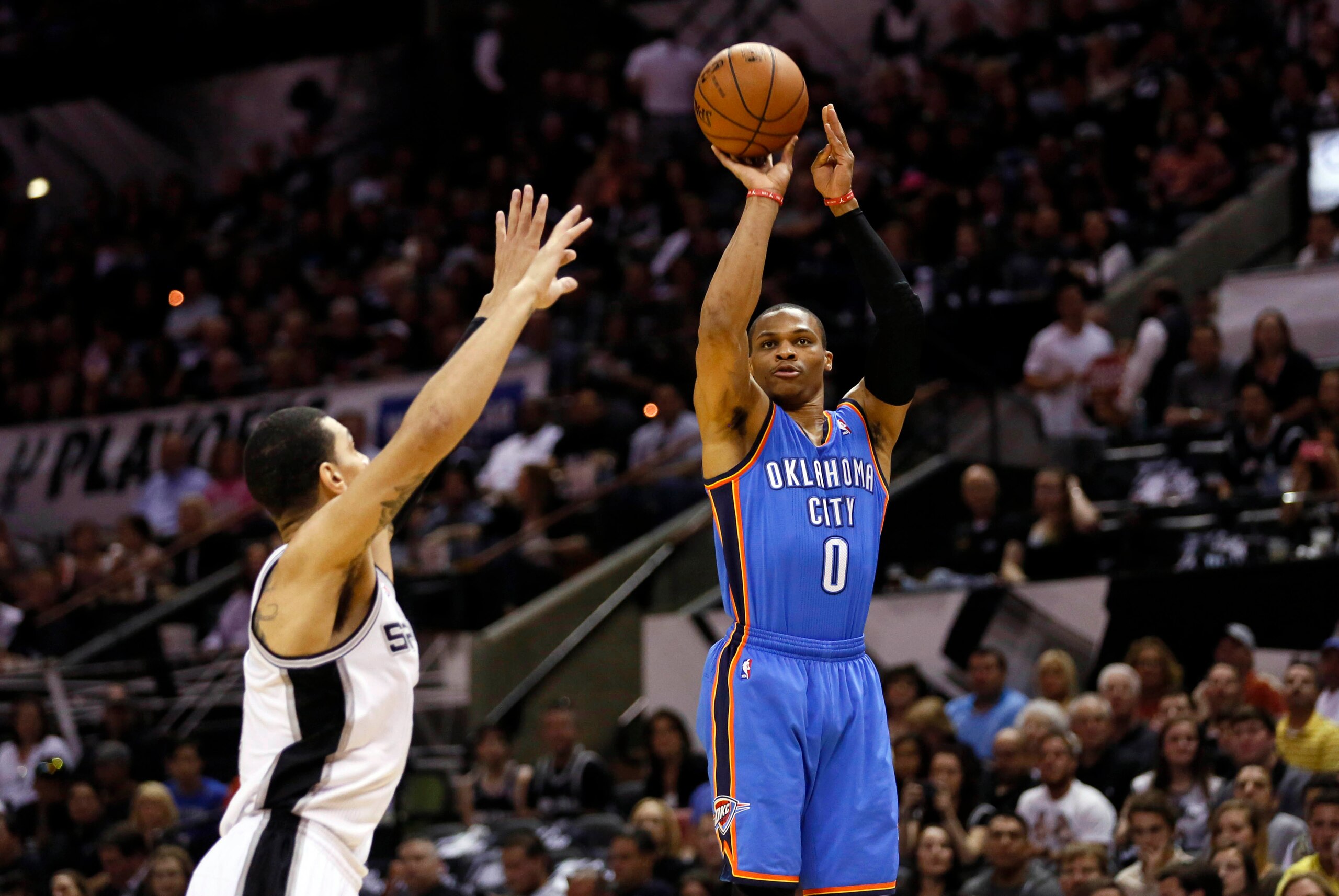 May 21, 2014; San Antonio, TX, USA; Oklahoma City Thunder guard Russell Westbrook (0) shoots the ball over San Antonio Spurs guard Danny Green (4) in game two of the Western Conference Finals of the 2014 NBA Playoffs at AT&T Center. Mandatory Credit: Soob