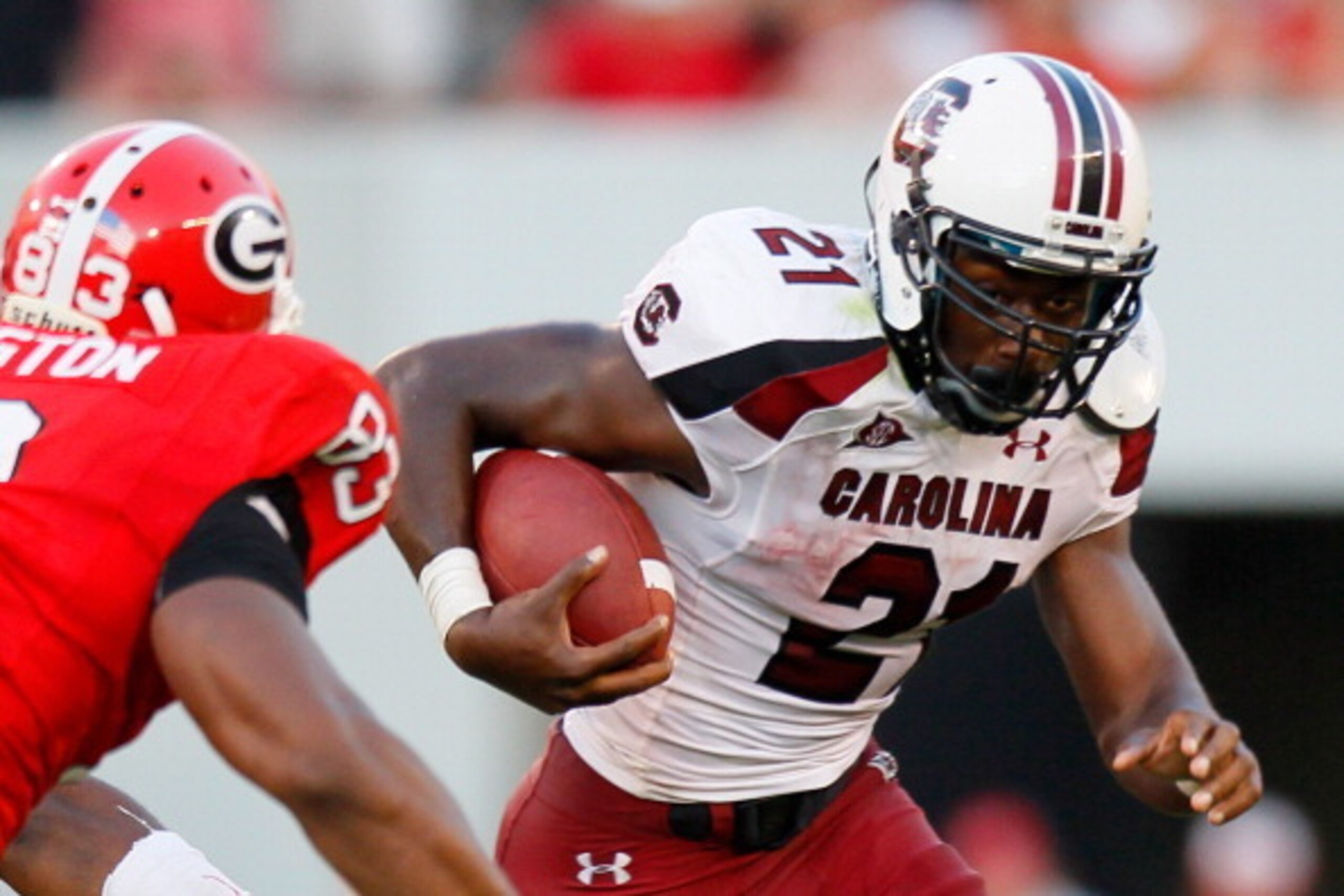 ATHENS, GA - SEPTEMBER 10:  Marcus Lattimore #21 of the South Carolina Gamecocks rushes upfield against Cornelius Washington #83 of the Georgia Bulldogs at Sanford Stadium on September 10, 2011 in Athens, Georgia.  (Photo by Kevin C. Cox/Getty Images)