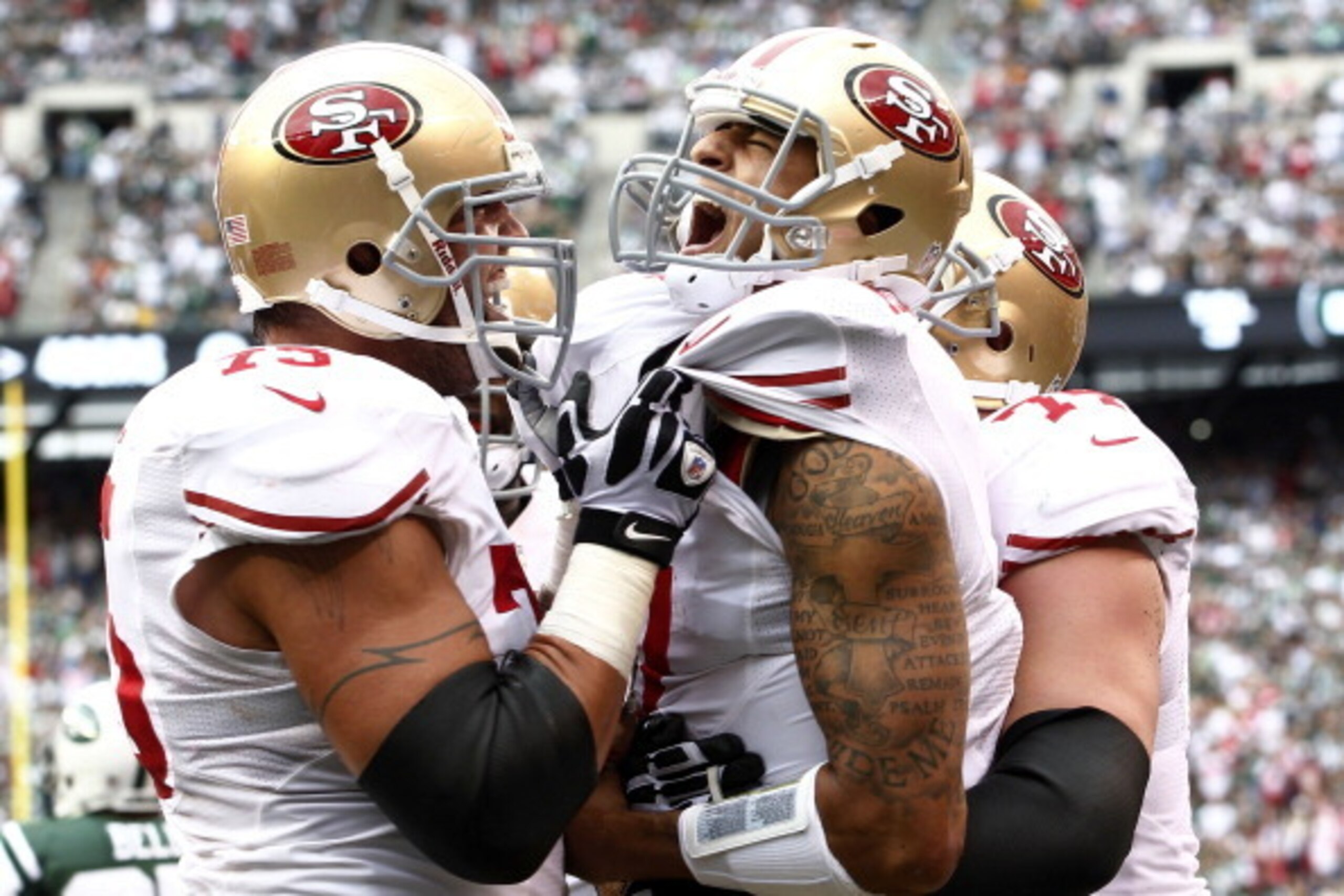 EAST RUTHERFORD, NJ - SEPTEMBER 30:  Colin Kaepernick #7 celebrates a touchdown with Alex Boone #75 and Joe Staley #74 of the San Francisco 49ers during a game against the New York Jets at MetLife Stadium on September 30, 2012 in East Rutherford, New Jers