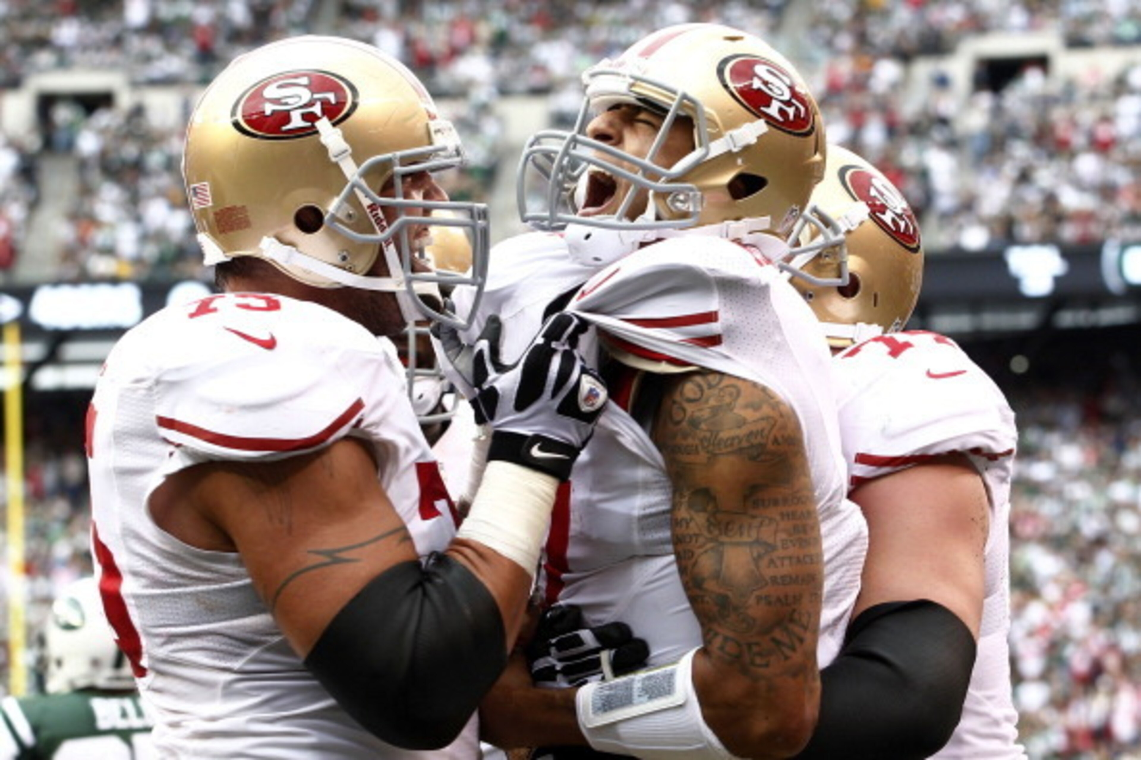 EAST RUTHERFORD, NJ - SEPTEMBER 30:  Colin Kaepernick #7 celebrates a touchdown with Alex Boone #75 and Joe Staley #74 of the San Francisco 49ers during a game against the New York Jets at MetLife Stadium on September 30, 2012 in East Rutherford, New Jers
