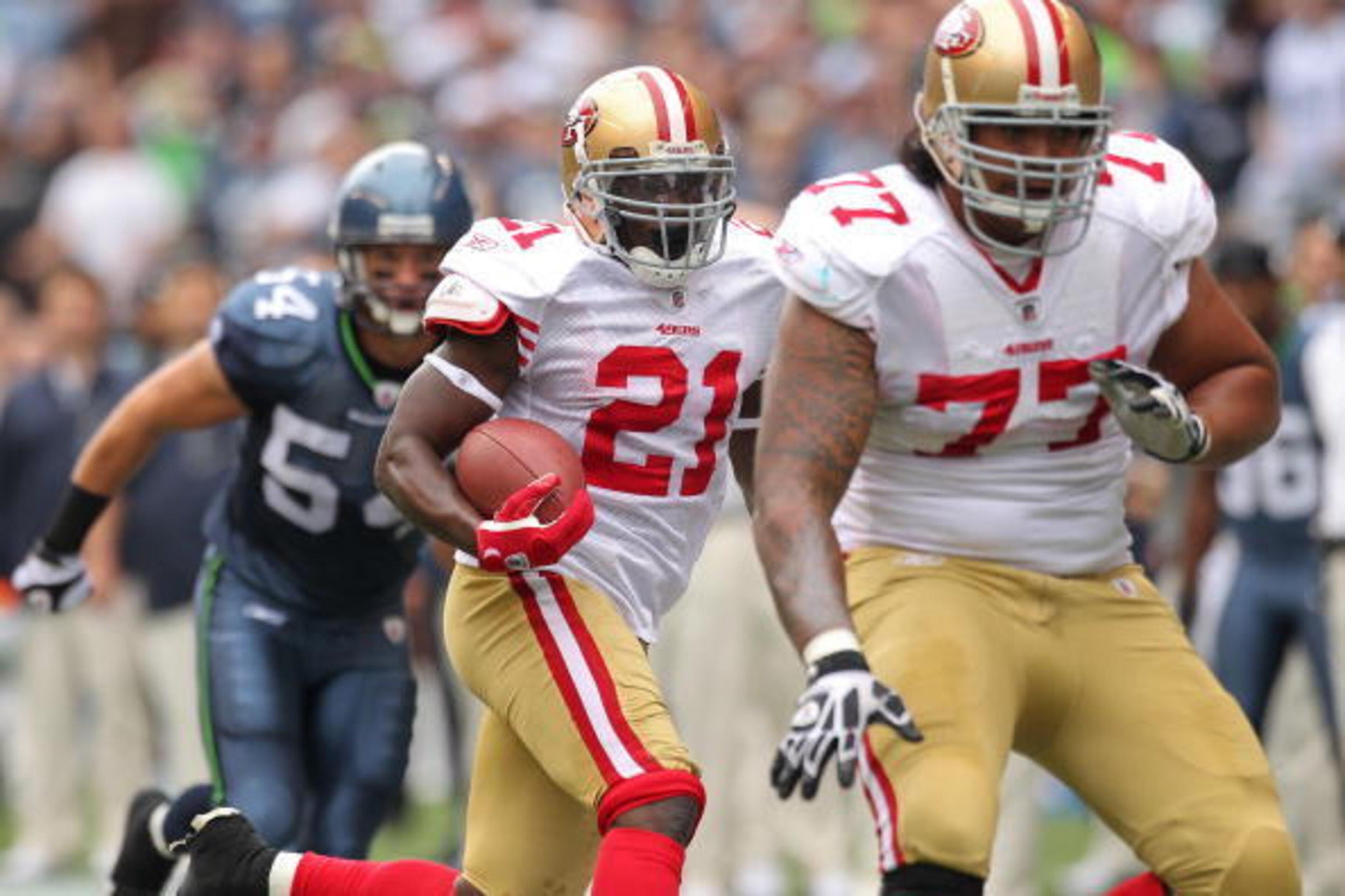SEATTLE - SEPTEMBER 12:  Running back Frank Gore #21 of the San Francisco 49ers rushes as Mike Iupati #77 blocks for him during the NFL season opener against the Seattle Seahawks at Qwest Field on September 12, 2010 in Seattle, Washington. (Photo by Otto 