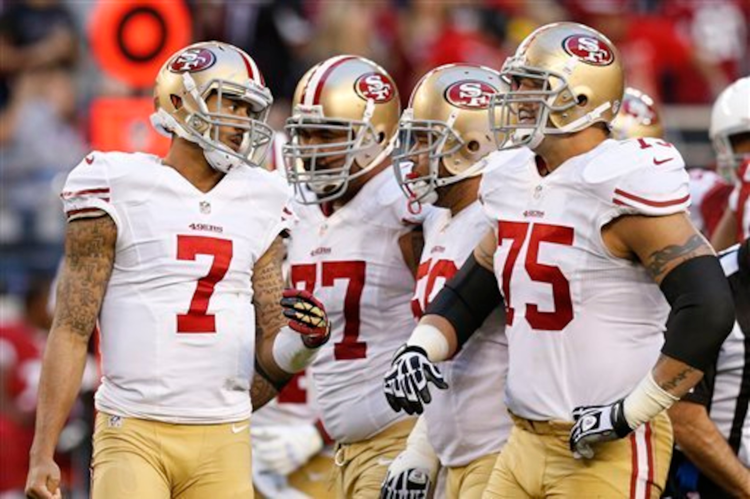 Iupati (No. 77) and Boone (No. 75) help keep a clean interior pocket for Kaepernick.