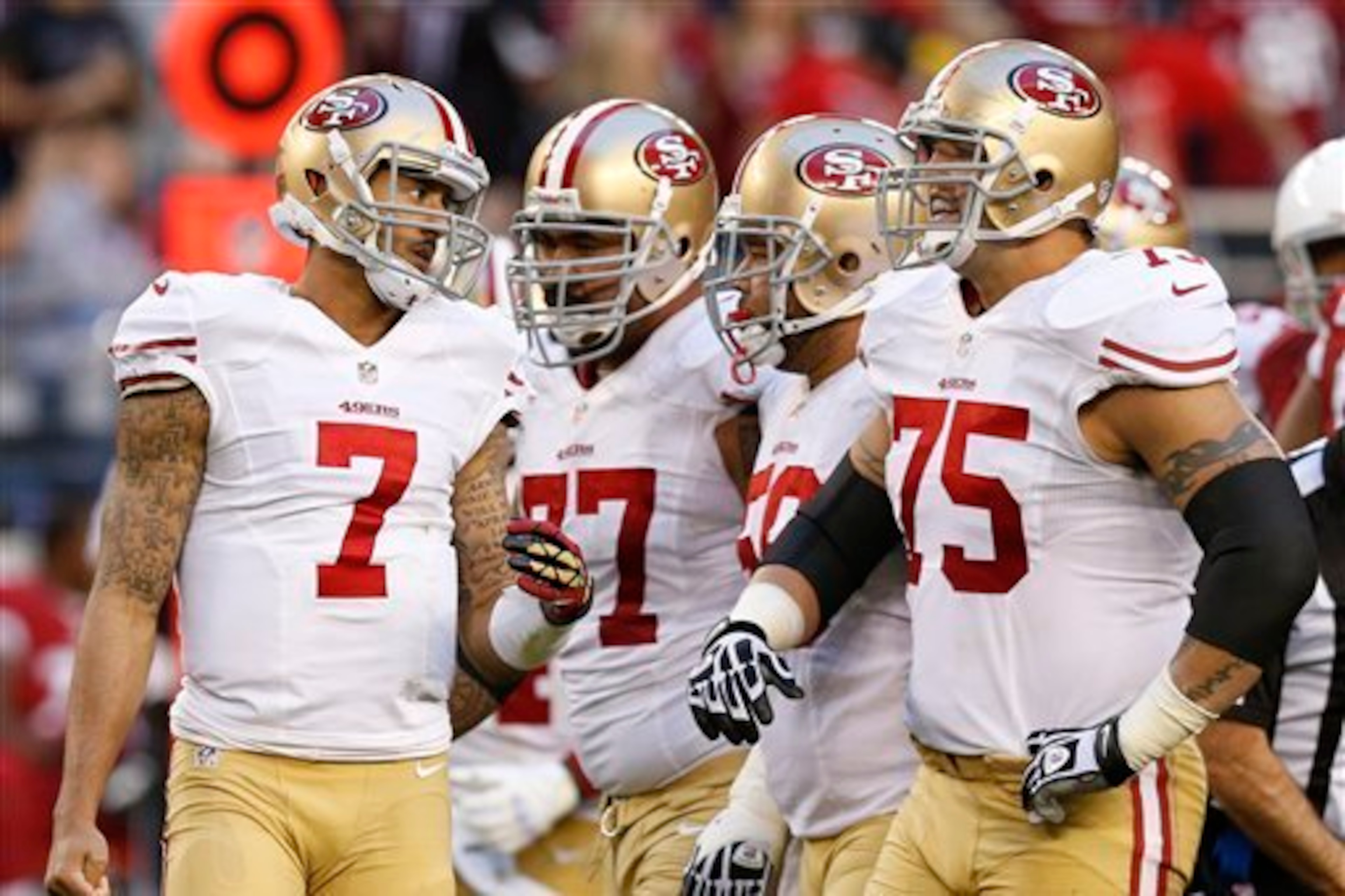 Iupati (No. 77) and Boone (No. 75) help keep a clean interior pocket for Kaepernick.