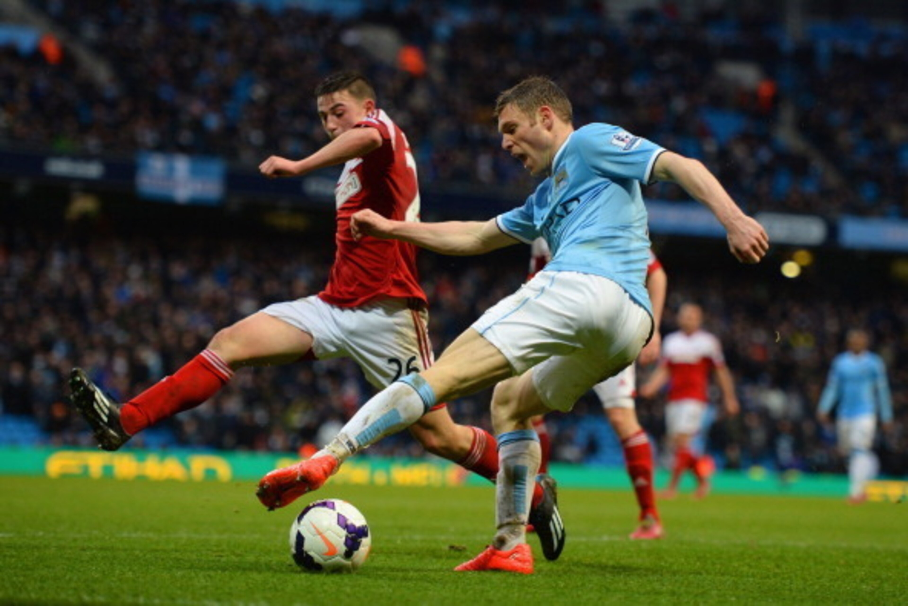 MANCHESTER, ENGLAND - MARCH 22:  Patrick Roberts of Fulham goes into block the cross from James Milner of Manchester City lduring the Barclays Premier League match between Manchester City and Fulham at Etihad Stadium on March 22, 2014 in Manchester, Engla