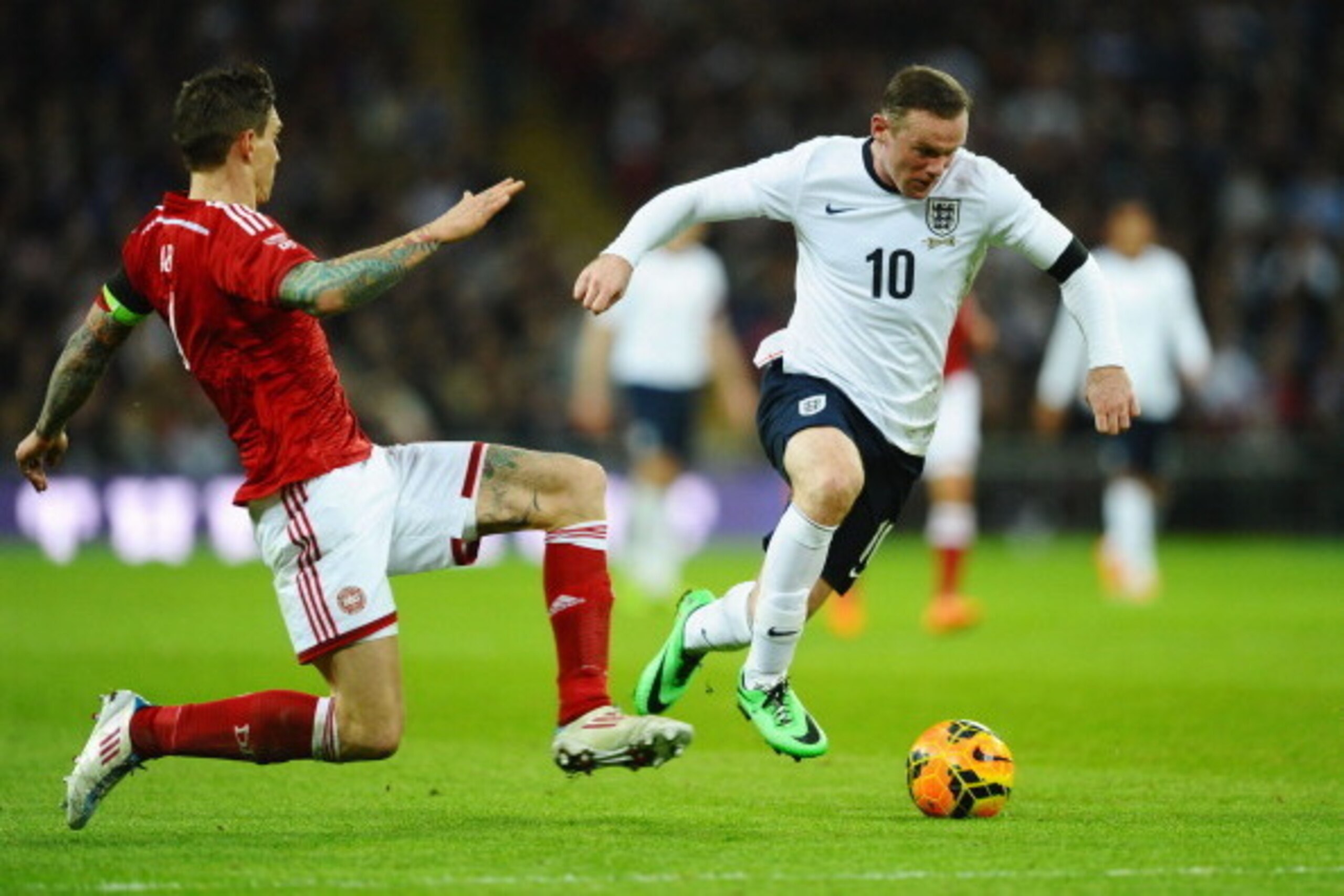 LONDON, ENGLAND - MARCH 05: Wayne Rooney of England goes past Daniel Agger of Denmark during the International Friendly match between England and Denmark at Wembley Stadium on March 5, 2014 in London, England.  (Photo by Laurence Griffiths/Getty Images)