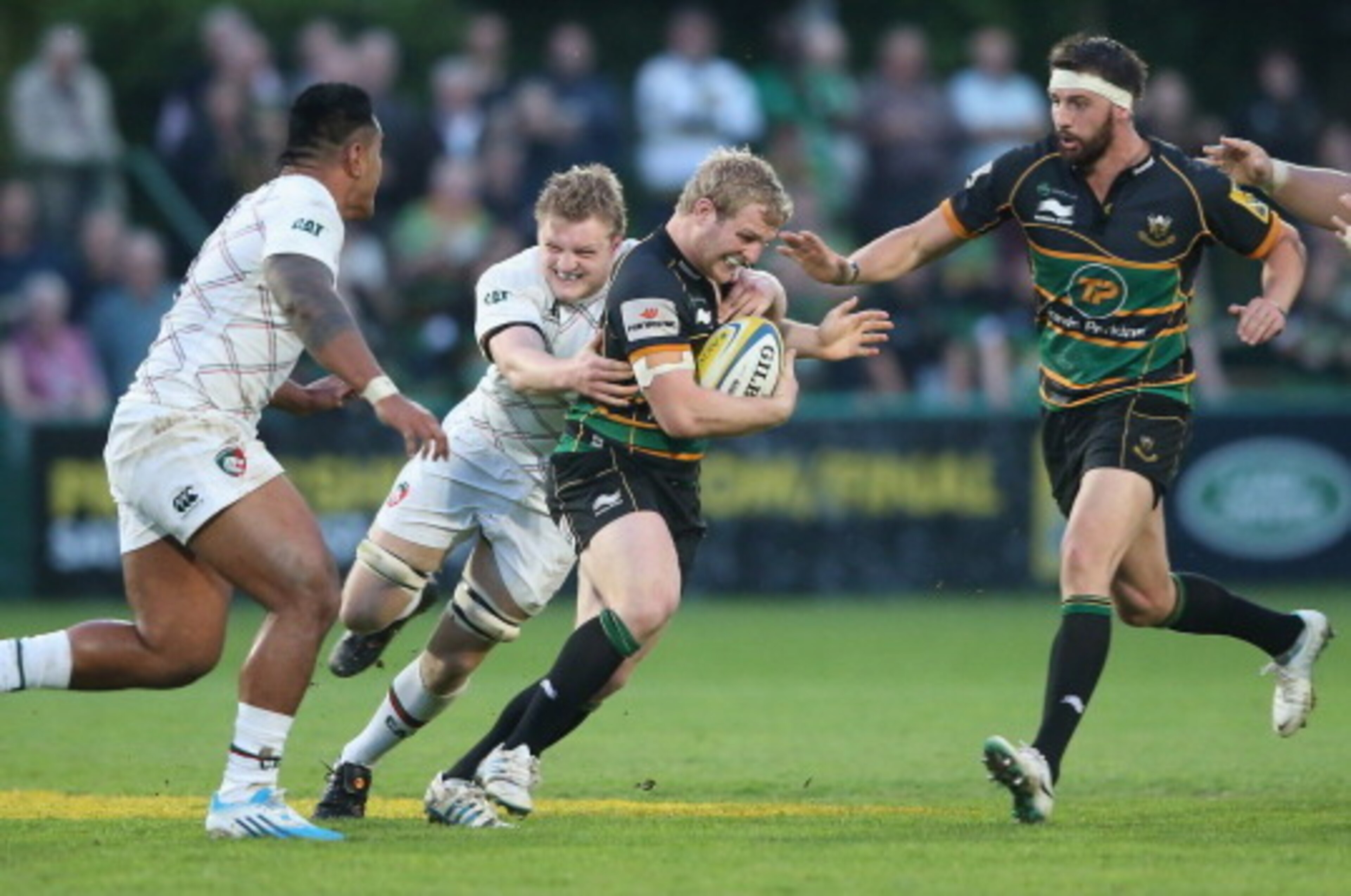 NORTHAMPTON, ENGLAND - MAY 16:  Mike Haywood of Northampton is tackled by Jamie Gibson during the Aviva Premiership semi final match between Northampton Saints and Leicester Tigers at Franklin's Gardens on May 16, 2014 in Northampton, England.  (Photo by 