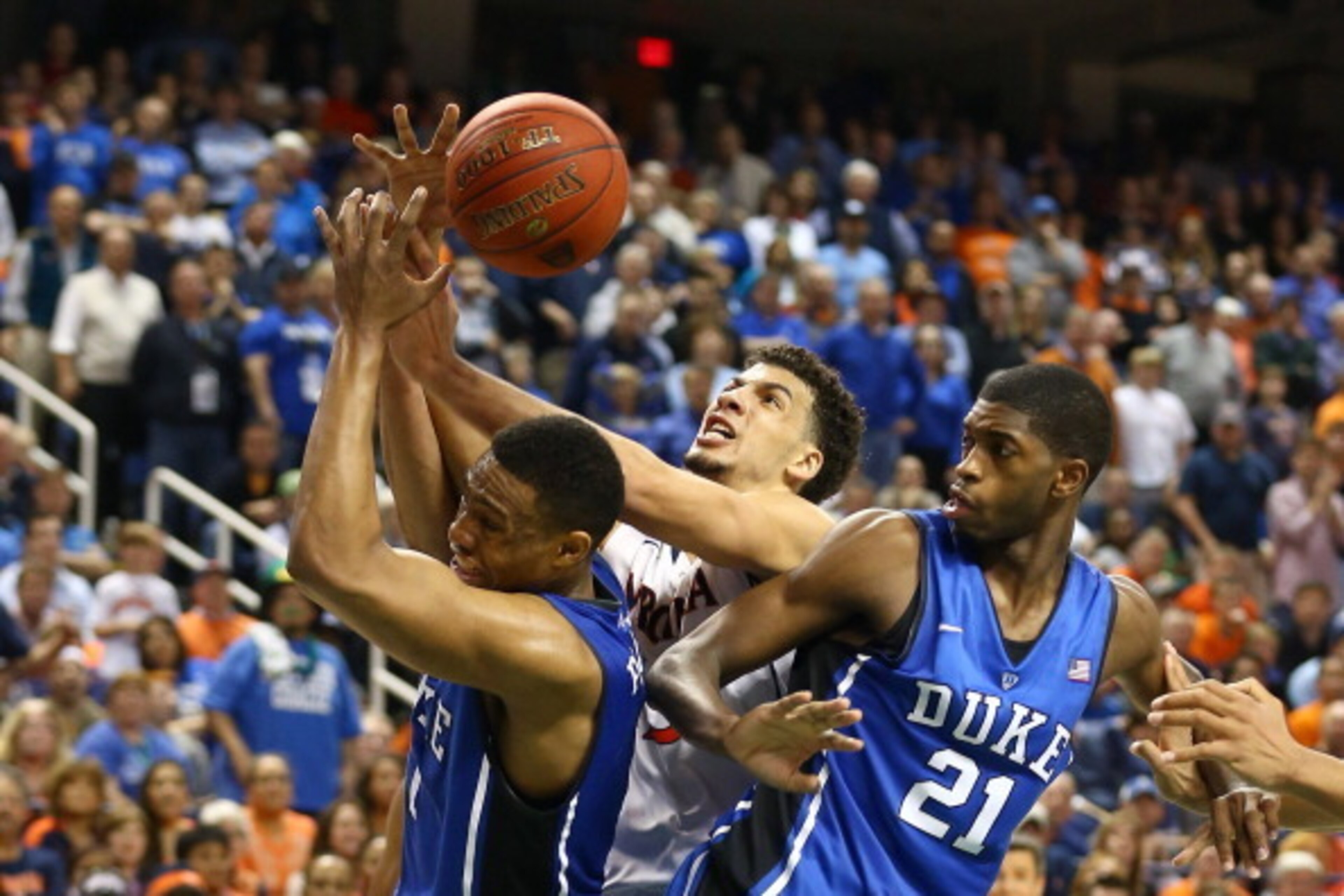 GREENSBORO, NC - MARCH 16: Anthony Gill #13 of the Virginia Cavaliers and Amile Jefferson #21 and Jabari Parker #1 of the Duke Blue Devils go for the ball during the finals of the 2014 Men's ACC Basketball Tournament at Greensboro Coliseum on March 16, 2 GREENSBORO, NC - MARCH 16: Anthony Gill #13 of the Virginia Cavaliers and Amile Jefferson #21 and Jabari Parker #1 of the Duke Blue Devils go for the ball during the finals of the 2014 Men's ACC Basketball Tournament at Greensboro Coliseum on March 16, 2