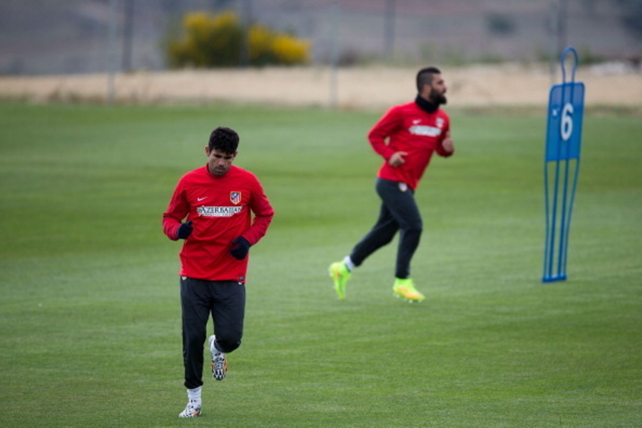 SEGOVIA, SPAIN - MAY 22:  Diego Costa (L) of Atletico de Madrid excersises with his teammate Arda Turan (R) during a training session prior to UEFA Champions League Final between Club Atletico de Madrid and Real Madrid CF on May 22, 2014 at Los Angeles de