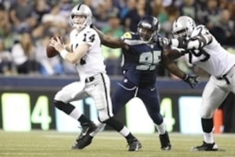 Aug 29, 2013; Seattle, WA, USA; Seattle Seahawks defensive end Benson Mayowa (95) beats a block by Oakland Raiders tackle Willie Smith (79) to force a fumble by quarterback Matthew McGloin (14) during the second half at CenturyLink Field. Mandatory Credit