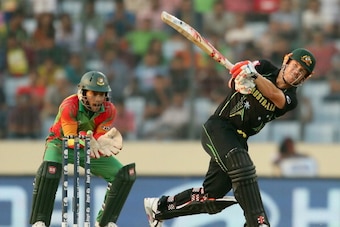 DHAKA, BANGLADESH - APRIL 01:  David Warner of Australia hits a six as Mushfiqur Rahim of Bangladesh looks on during the ICC World Twenty20 Bangladesh 2014 match between Bangladesh and Australia at Sher-e-Bangla Mirpur Stadium on April 1, 2014 in Dhaka, B