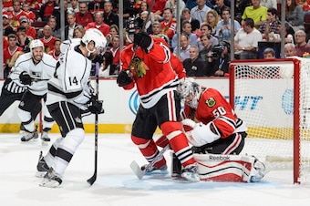 CHICAGO, IL - MAY 21: Justin Williams #14 of the Los Angeles Kings is able to score on goalie Corey Crawford #50 of the Chicago Blackhawks, as teammate Dwight King #74 watches in the background, in Game Two of the Western Conference Final during the 2014 