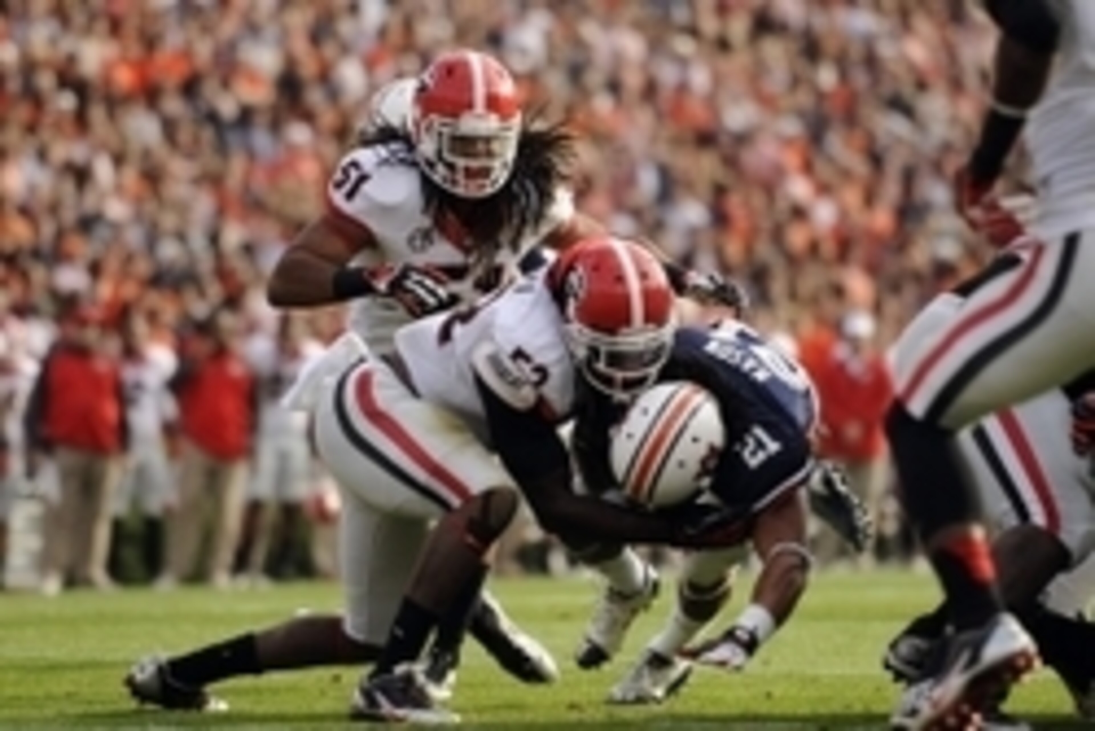 Nov 16, 2013; Auburn, AL, USA; Auburn Tigers running back Tre Mason (21) is tackled by Georgia Bulldogs linebacker Amarlo Herrera (52) during the first half at Jordan Hare Stadium. Mandatory Credit: Shanna Lockwood-USA TODAY Sports Nov 16, 2013; Auburn, AL, USA; Auburn Tigers running back Tre Mason (21) is tackled by Georgia Bulldogs linebacker Amarlo Herrera (52) during the first half at Jordan Hare Stadium. Mandatory Credit: Shanna Lockwood-USA TODAY Sports