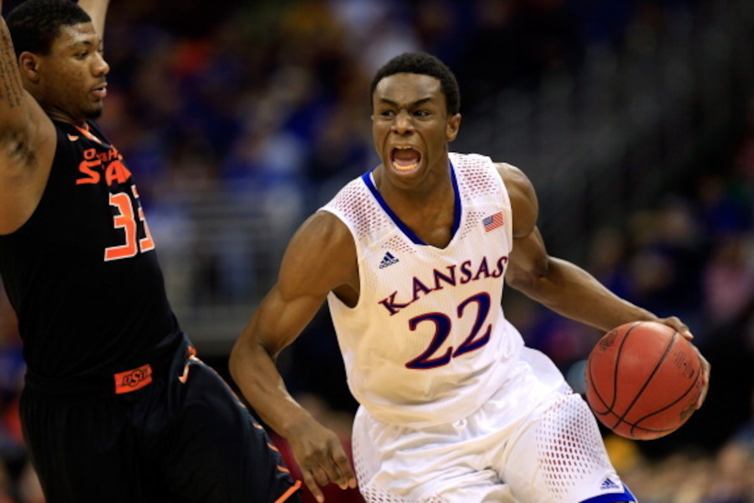 KANSAS CITY, MO - MARCH 13: Andrew Wiggins #22 of the Kansas Jayhawks drives upcourt as Marcus Smart #33 of the Oklahoma State Cowboys defends during the Big 12 Basketball Tournament quarterfinal game at Sprint Center on March 13, 2014 in Kansas City, Mi KANSAS CITY, MO - MARCH 13: Andrew Wiggins #22 of the Kansas Jayhawks drives upcourt as Marcus Smart #33 of the Oklahoma State Cowboys defends during the Big 12 Basketball Tournament quarterfinal game at Sprint Center on March 13, 2014 in Kansas City, Mi