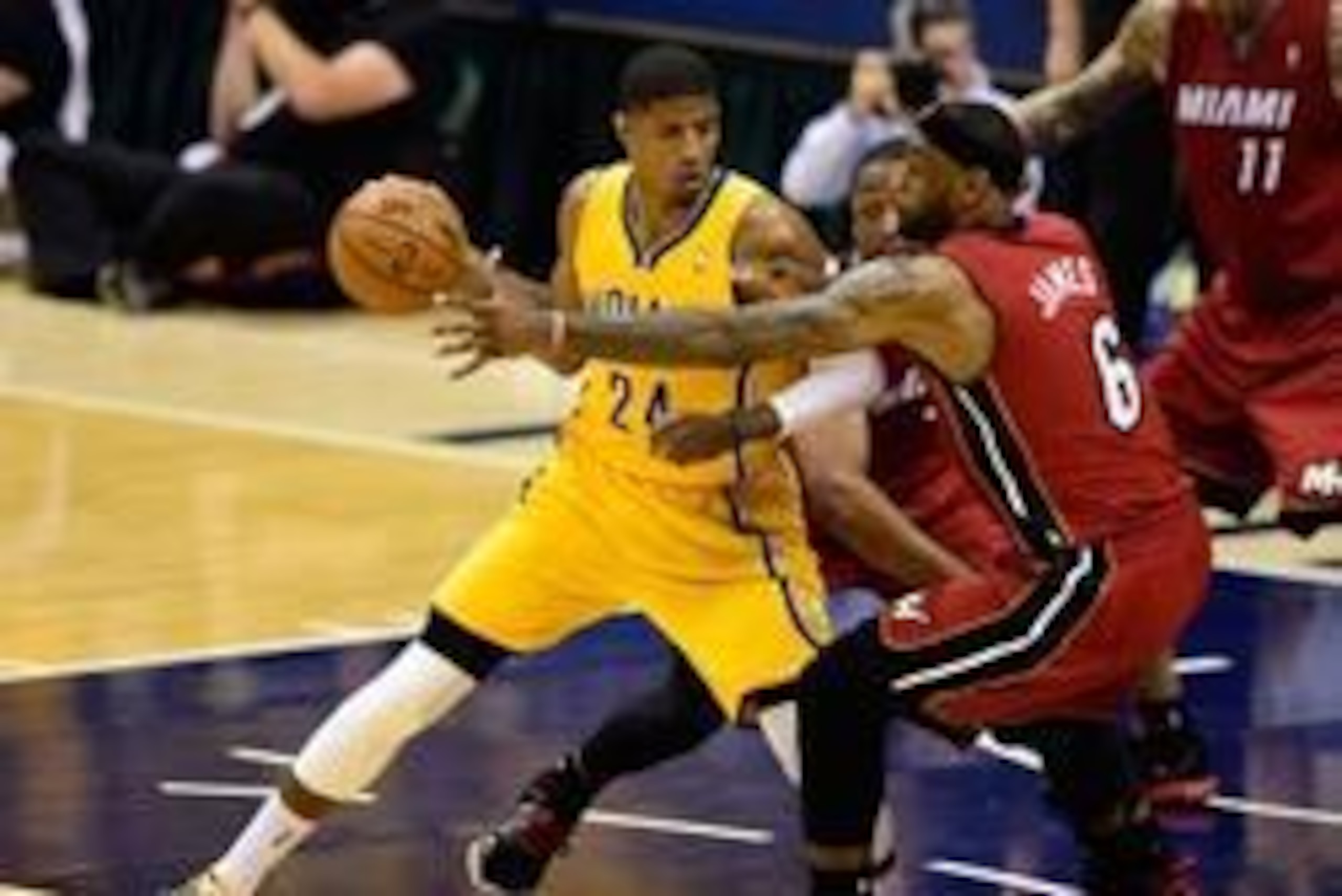 May 18, 2014; Indianapolis, IN, USA;Indiana Pacers forward Paul George (24) attempts to keep the ball away from Miami Heat forward LeBron James (6) and Miami Heat guard Dwyane Wade (3) during the second half of game one of the Eastern Conference Finals of