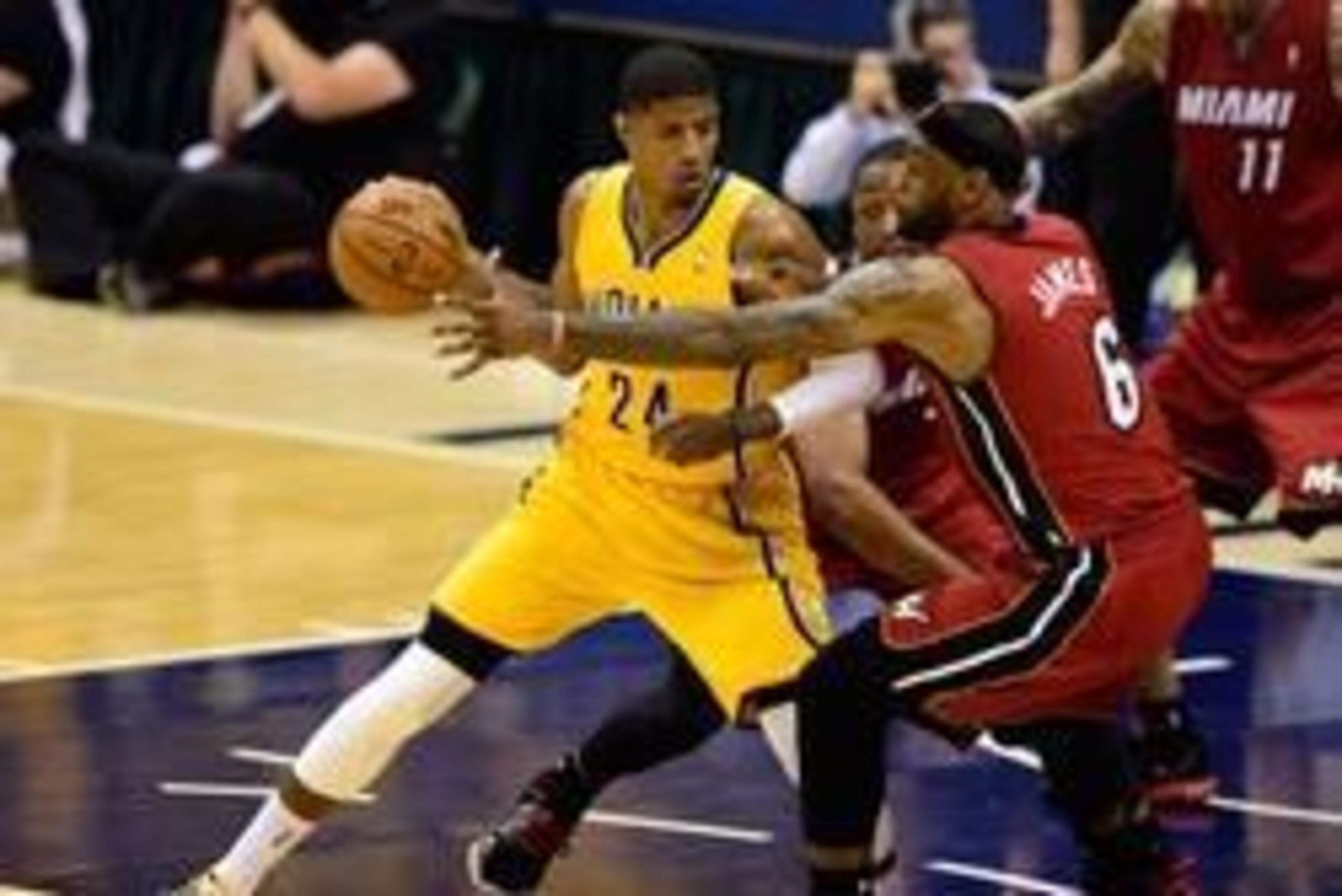 May 18, 2014; Indianapolis, IN, USA;Indiana Pacers forward Paul George (24) attempts to keep the ball away from Miami Heat forward LeBron James (6) and Miami Heat guard Dwyane Wade (3) during the second half of game one of the Eastern Conference Finals of