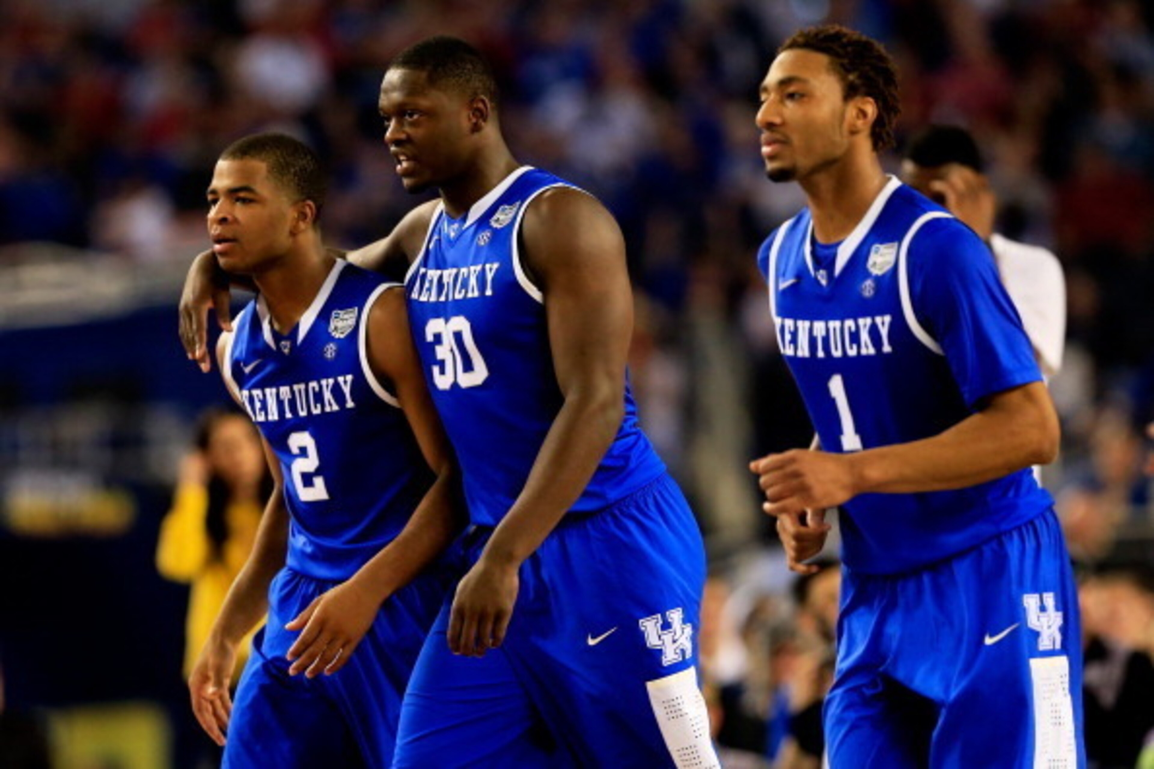 ARLINGTON, TX - APRIL 07: Aaron Harrison #2, Julius Randle #30, and James Young #1 of the Kentucky Wildcats look on during the NCAA Men's Final Four Championship against the Connecticut Huskies at AT&T Stadium on April 7, 2014 in Arlington, Texas.  (Photo