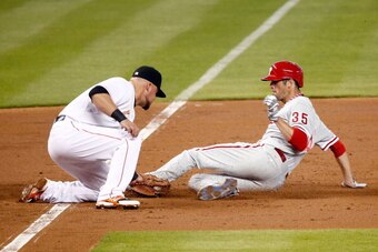 MIAMI, FL - MAY 22: Casey McGehee #9 of the Miami Marlins tags out Cole Hamels #35 of the Philadelphia Phillies during the third inning of the game at Marlins Park on May 22, 2014 in Miami, Florida.  (Photo by Rob Foldy/Getty Images)