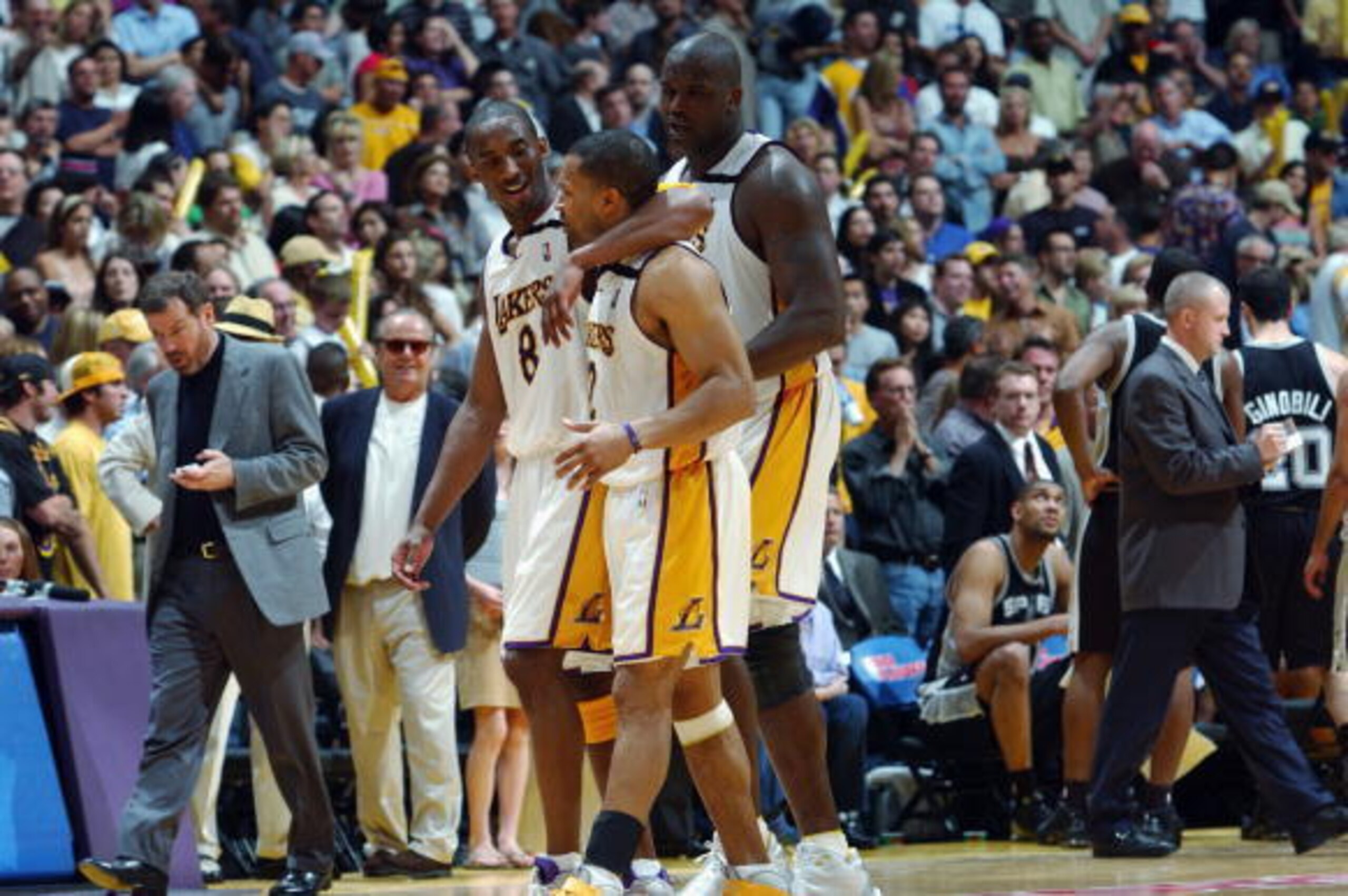 LOS ANGELES - MAY 11:  Kobe Bryant #8 of the Los Angeles Lakers hugs teammate Derek Fisher #2 as they walk to the bench along with Shaquille O'Neal #34 against the San Antonio Spurs in Game four of the Western Conference Semifinals during the 2003 NBA Pla