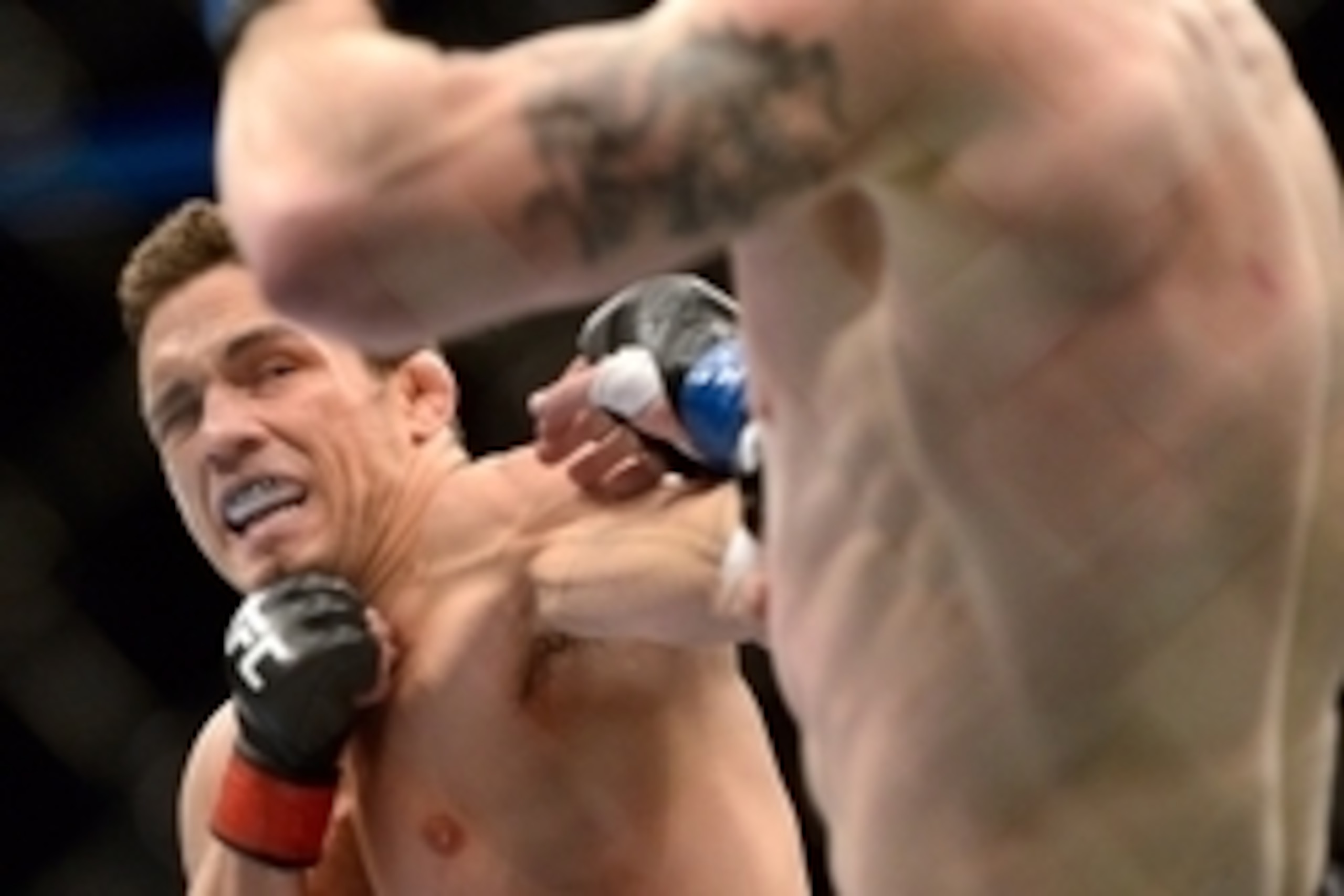 Mar 16, 2013; Montreal, Quebec, CAN;  Jake Ellenberger (red) lands a body punch on Nate Marquardt (blue) during their main card bout at UFC 158 at the Bell Centre. Mandatory Credit: Eric Bolte-USA TODAY Sports
