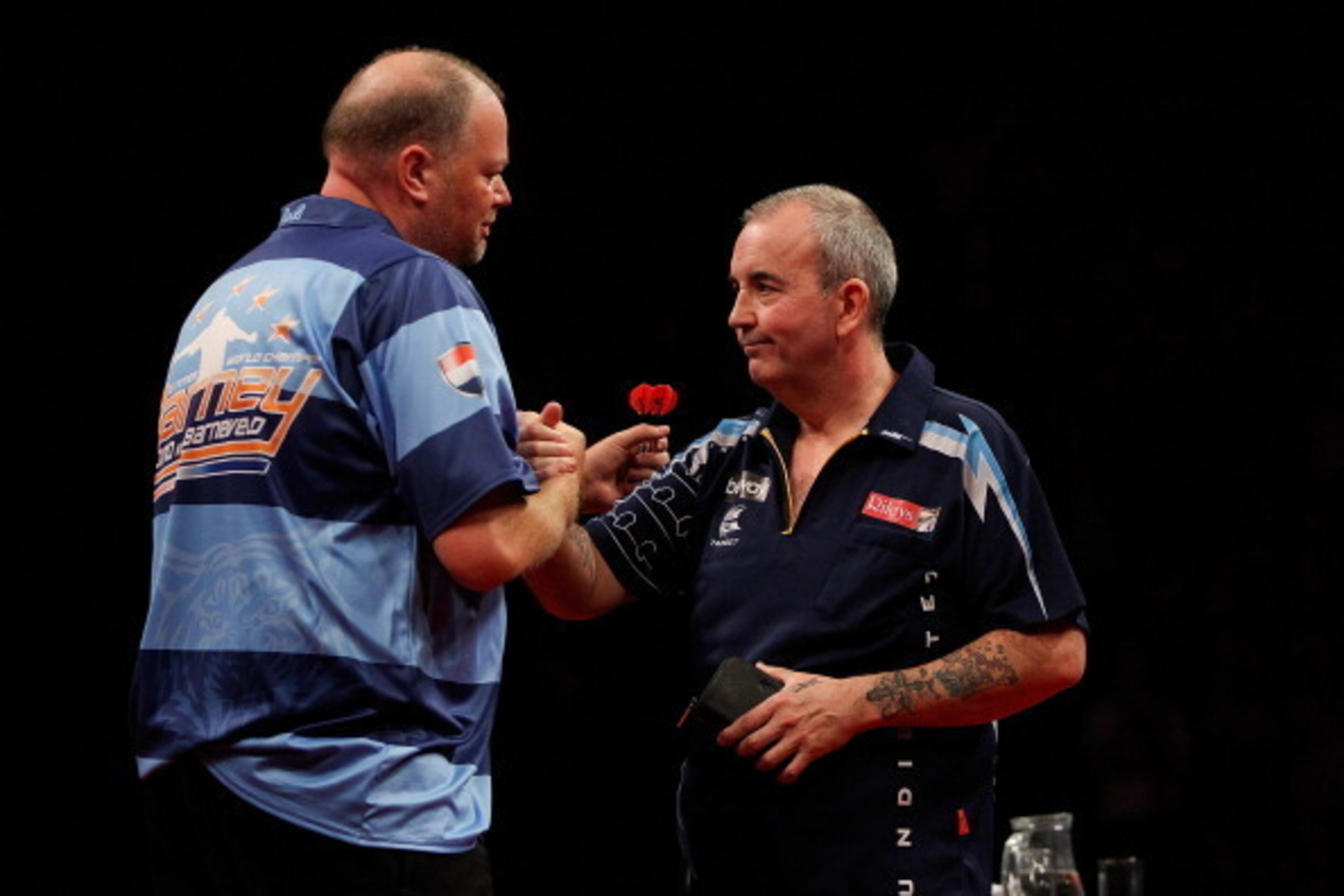 LONDON, ENGLAND - MAY 22: Raymond van Barneveld of the Netherlands shakes hands with Phil Taylor of England after the McCoys Premier League Darts Play-Offs Semi Final match between Raymond van Barneveld and Phil Taylor at O2 Arena on May 22, 2014 in Londo LONDON, ENGLAND - MAY 22: Raymond van Barneveld of the Netherlands shakes hands with Phil Taylor of England after the McCoys Premier League Darts Play-Offs Semi Final match between Raymond van Barneveld and Phil Taylor at O2 Arena on May 22, 2014 in Londo