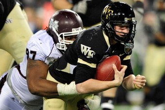 NASHVILLE, TN - DECEMBER 30:  Josh Boyd #97 of the Mississippi State Bulldogs sacks quarterback Tanner Price #10 of the Wake Forest Demon Deacons during play at the Franklin American Mortgage Music City Bowl at LP Field on December 30, 2011 in Nashville, 