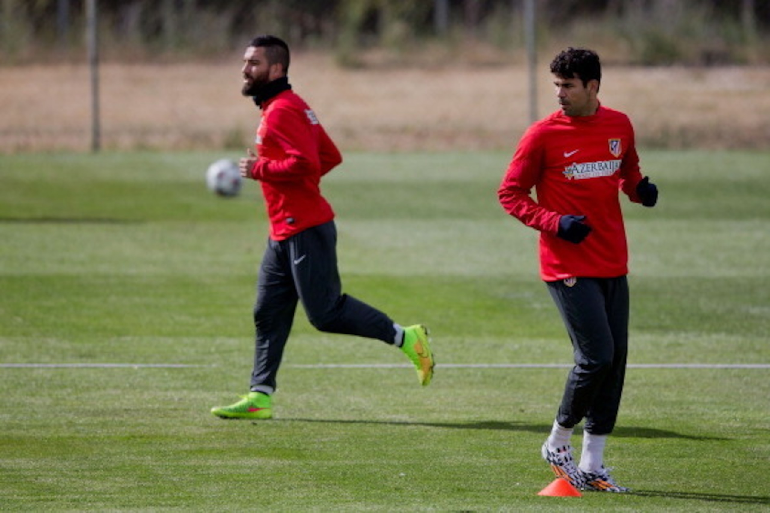SEGOVIA, SPAIN - MAY 22:  Diego Costa (R) of Atletico de Madrid excersises with his teammate Arda Turan (L) during a training session prior to UEFA Champions League Final between Club Atletico de Madrid and Real Madrid CF on May 22, 2014 at Los Angeles de