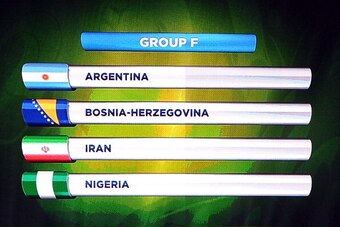 COSTA DO SAUIPE, BRAZIL - DECEMBER 06:  Group F containing Argentina, Bosnia-Herzegovina, Iran and Nigeria is displayed on the big screen on stage behind the draw assistants, Fernanda Lima and FIFA General Secretary Jerome Valcke during the Final Draw for