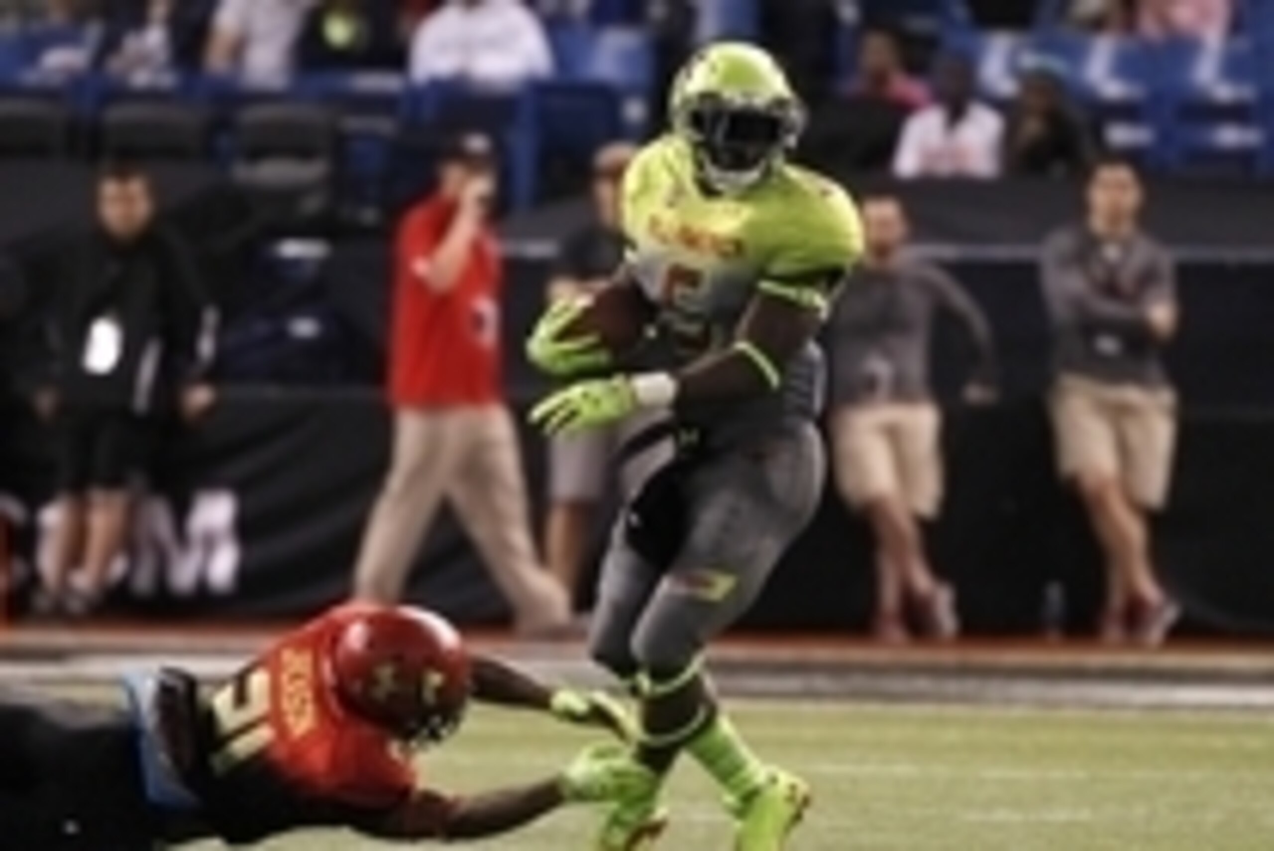 Jan 2, 2014; St. Petersburg, FL, USA;  Team Nitro cornerback Jabrill Peppers (5) runs with the ball as Team Hightlight cornerback  Adoree Jackson (21) defends during the second half at Tropicana Field. Team Highlight defeated the Team Nitro 31-21. Mandato