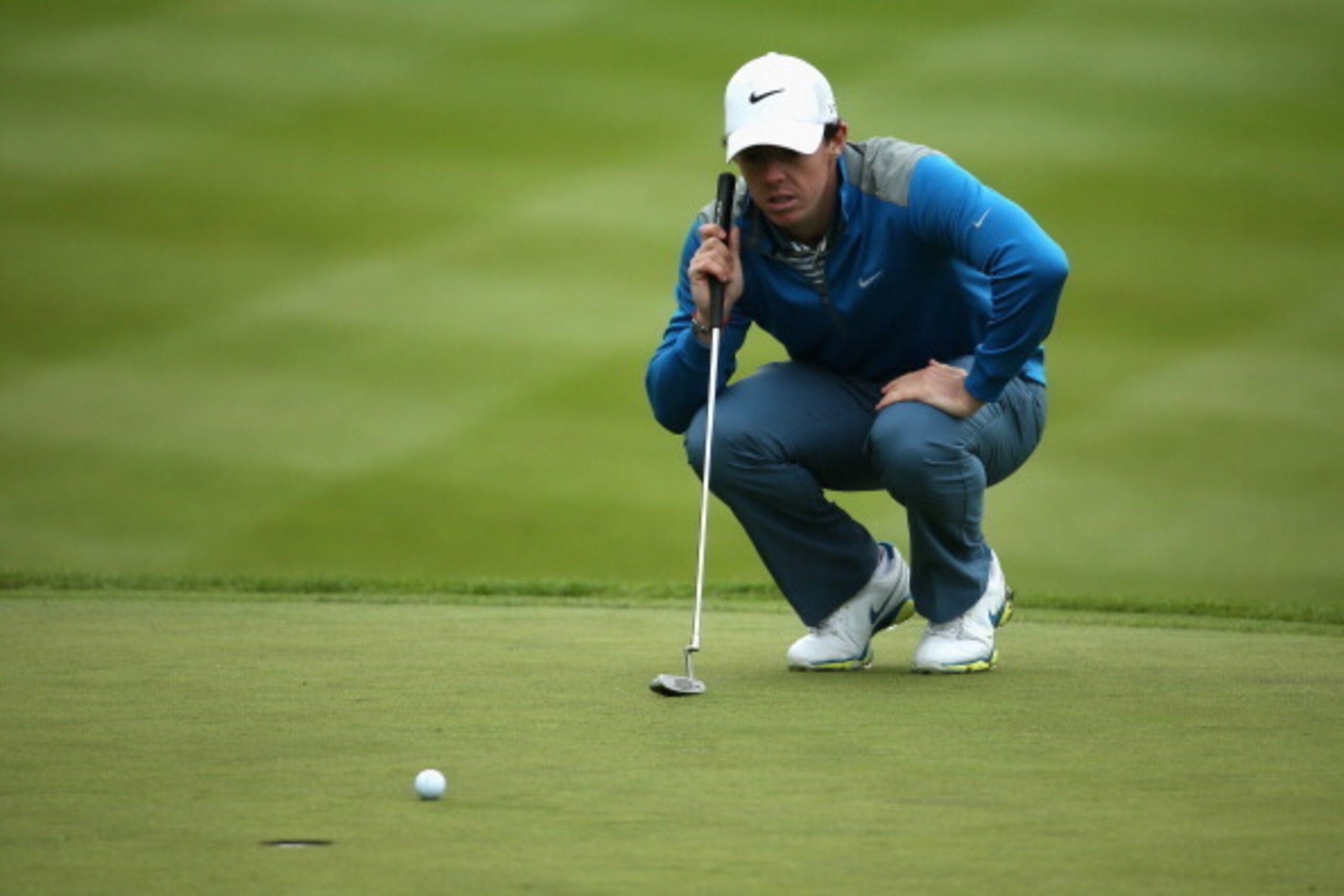 VIRGINIA WATER, ENGLAND - MAY 23:  Rory McIlroy of Northern Ireland lines up on the 18th green during day two of the BMW PGA Championship at Wentworth on May 23, 2014 in Virginia Water, England.  (Photo by Warren Little/Getty Images)