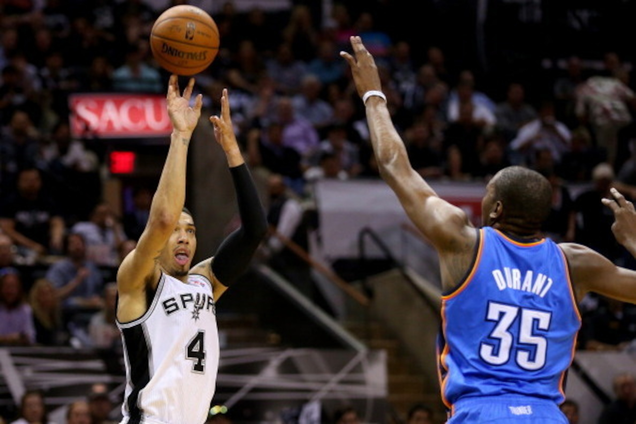 SAN ANTONIO, TX - MAY 21:  Danny Green #4 of the San Antonio Spurs makes a three-pointer over Kevin Durant #35 of the Oklahoma City Thunder in the first half in Game Two of the Western Conference Finals during the 2014 NBA Playoffs at AT&T Center on May 2