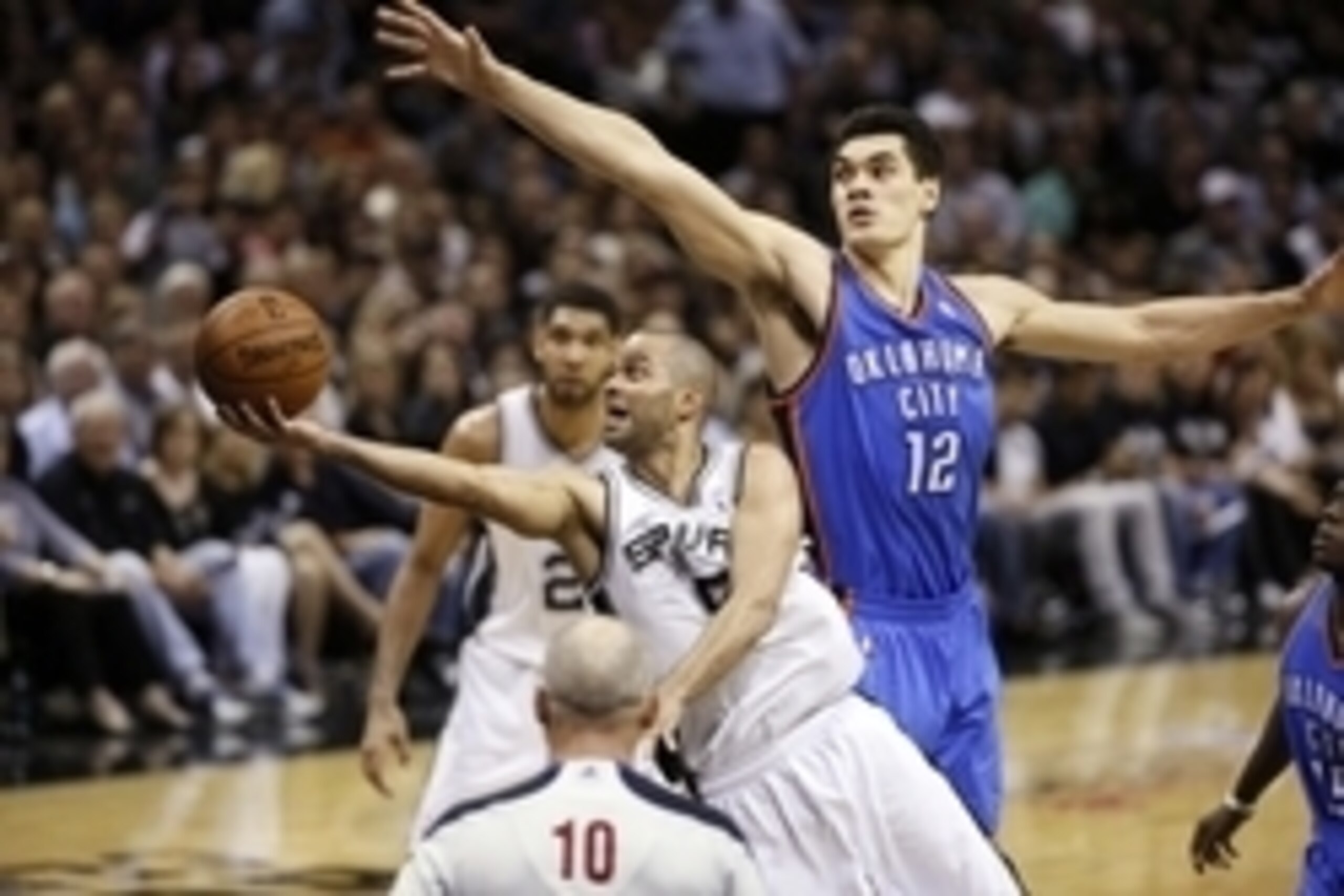 May 21, 2014; San Antonio, TX, USA; San Antonio Spurs guard Tony Parker (9) shoots the ball past Oklahoma City Thunder center Steven Adams (12) in game two of the Western Conference Finals of the 2014 NBA Playoffs at AT&T Center. Mandatory Credit: Soobum