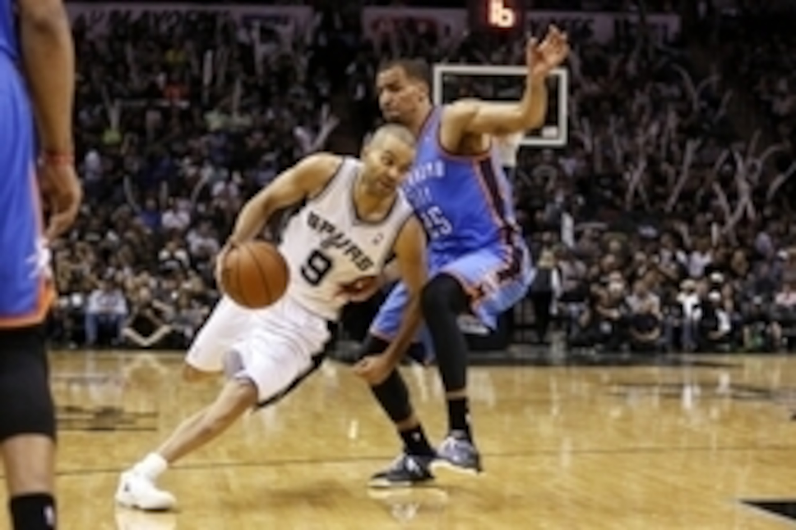 May 21, 2014; San Antonio, TX, USA; San Antonio Spurs guard Tony Parker (9) drives to the basket around Oklahoma City Thunder guard Thabo Sefolosha (25) in game two of the Western Conference Finals of the 2014 NBA Playoffs at AT&T Center. Mandatory Credit