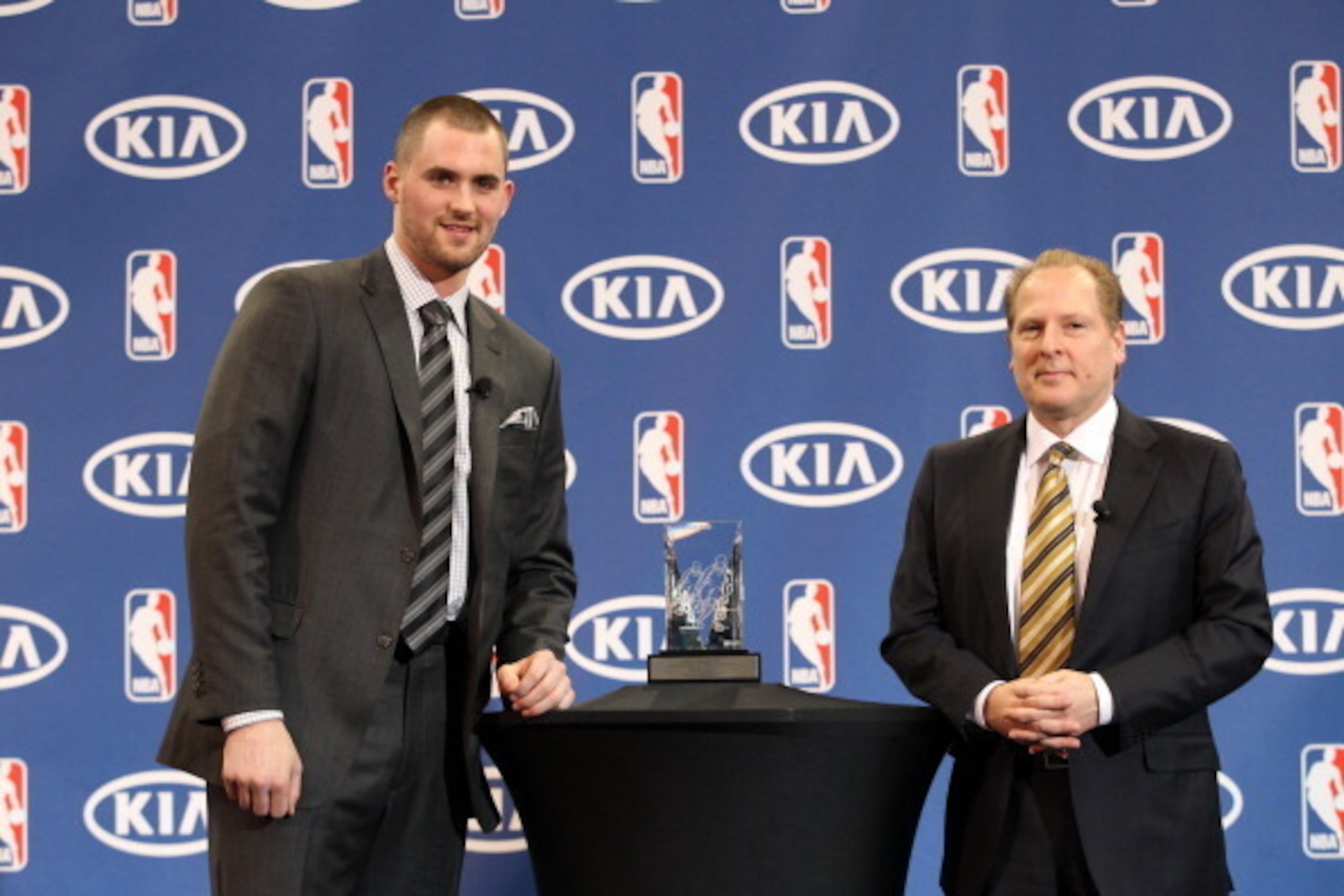 MINNEAPOLIS, MN - APRIL 21:  Kevin Love (L) of the Minnesota Timberwolves is presented with the 2010-11 Kia NBA Most Improved Player Award and keys to a 2011 Kia Sorento by David Kahn, Minnesota Timberwolves President of Basketball Operations at a press c