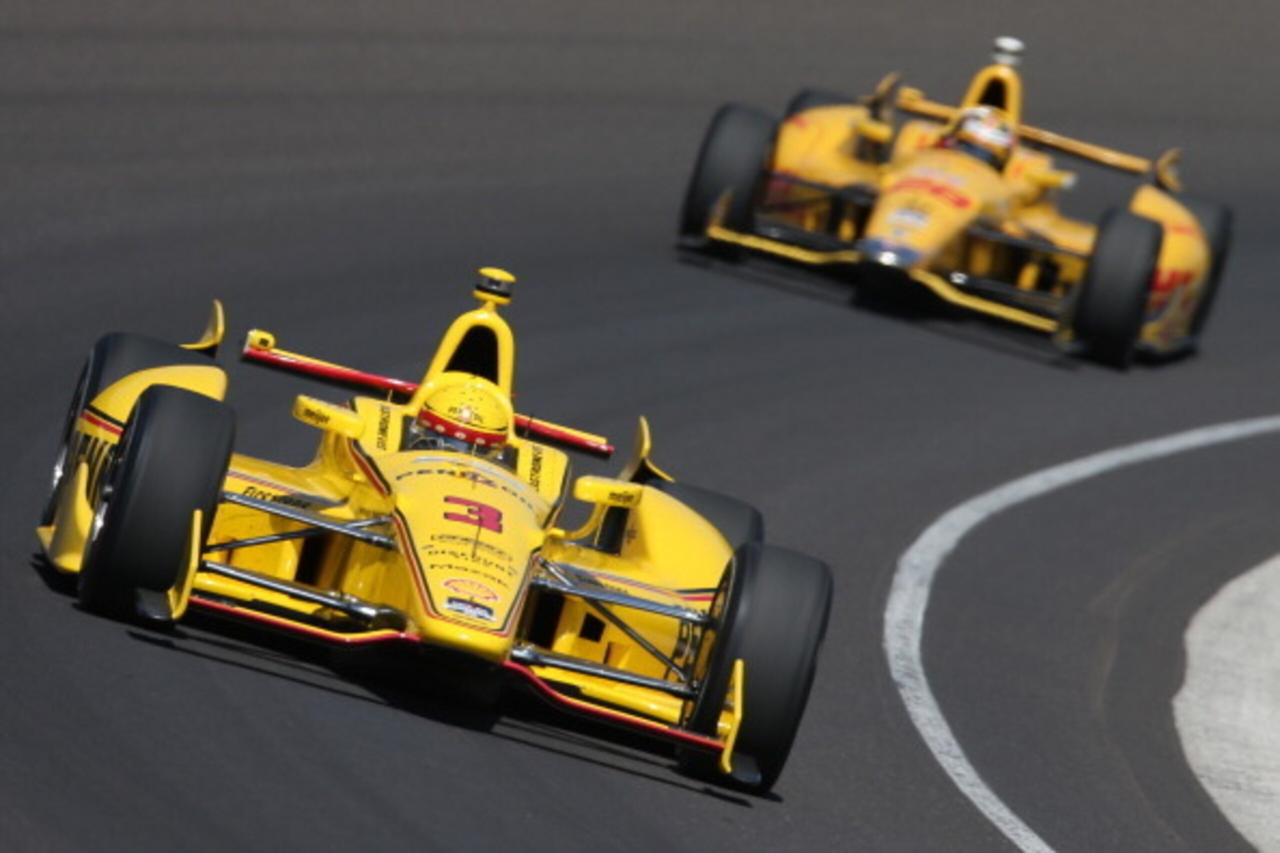 INDIANAPOLIS, IN - MAY 23:  Helio Castroneves of Brazil, driver of the #3 Pennzoil Ultra Platinum Penske Chevrolet Dallara, leads Ryan Hunter-Reay, driver of the #28 DHL Andretti Autosport Honda Dallara, during final practice on Carb Day for the 98th runn