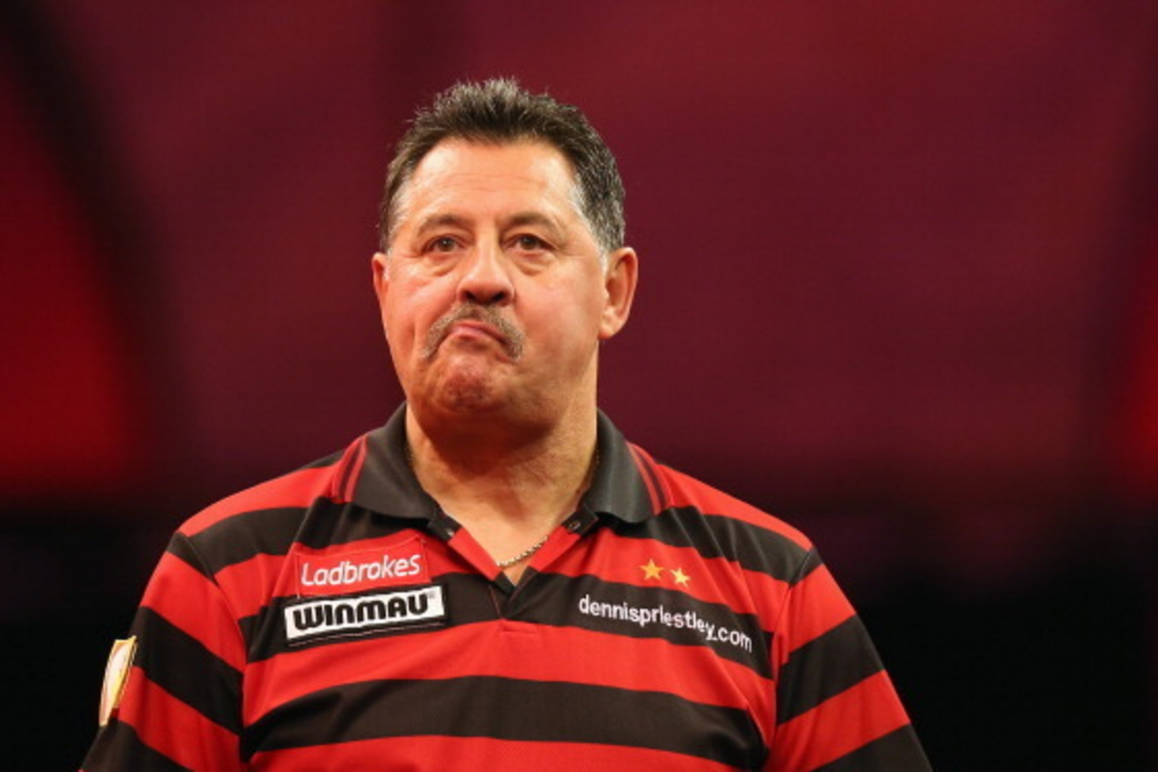 LONDON, ENGLAND - DECEMBER 19: Dennis Preistley of England reacts during his match against Ronnie Baxter during day 6 of the 2013 Ladbrokes.com World Darts Championship at Alexandra Palace on December 19, 2012 in London, England. (Photo by Bryn Lennon/G LONDON, ENGLAND - DECEMBER 19: Dennis Preistley of England reacts during his match against Ronnie Baxter during day 6 of the 2013 Ladbrokes.com World Darts Championship at Alexandra Palace on December 19, 2012 in London, England. (Photo by Bryn Lennon/G