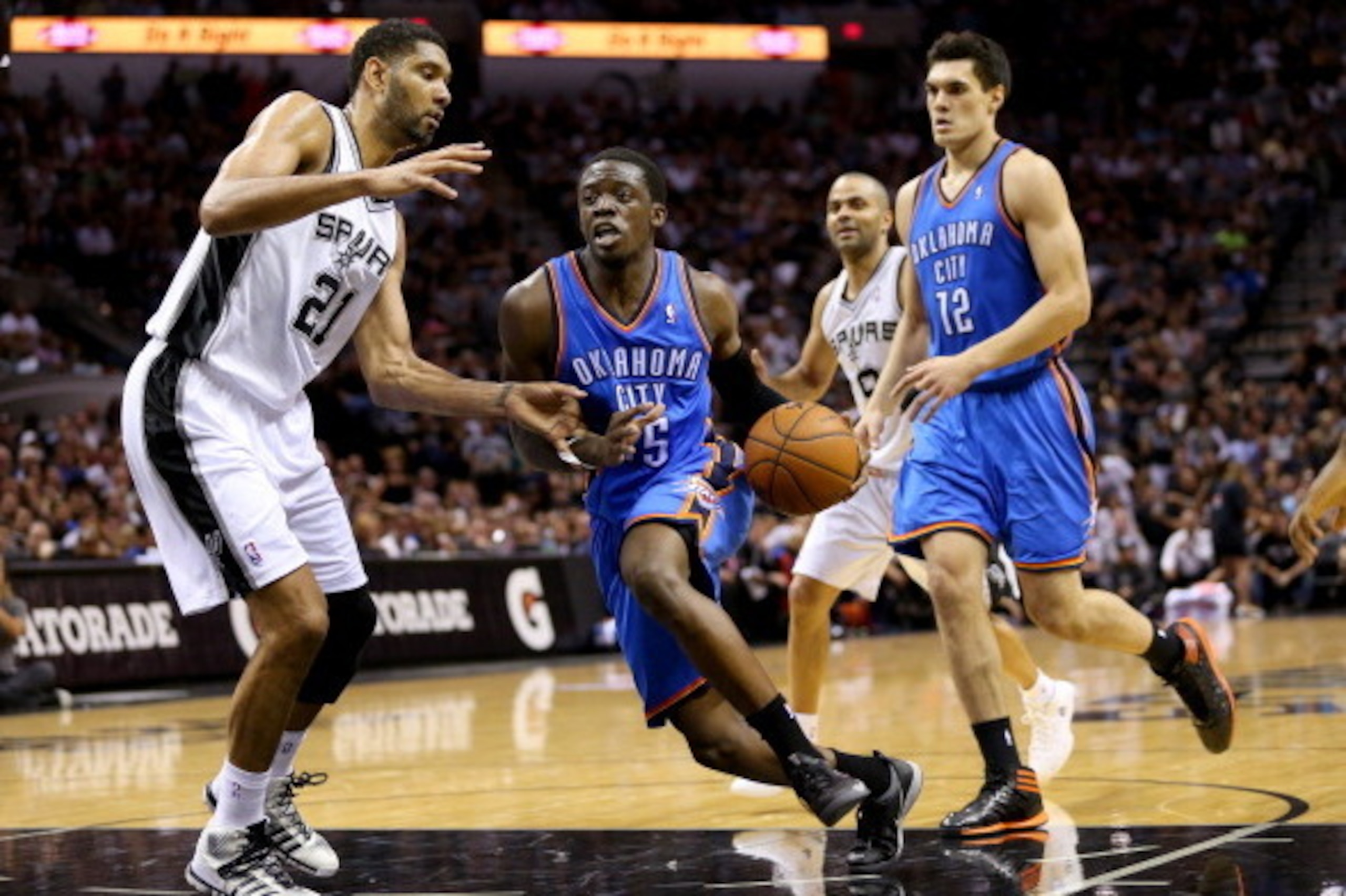 SAN ANTONIO, TX - MAY 21:  Reggie Jackson #15 of the Oklahoma City Thunder drives on Tim Duncan #21 of the San Antonio Spurs in the second half in Game Two of the Western Conference Finals during the 2014 NBA Playoffs at AT&T Center on May 21, 2014 in San