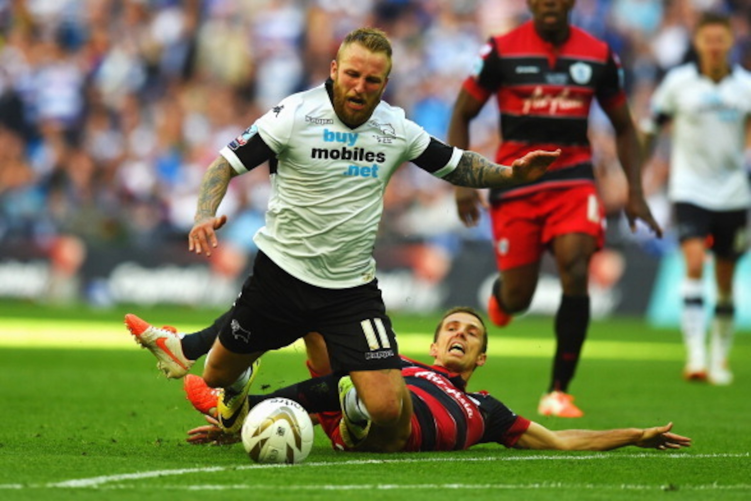 LONDON, ENGLAND - MAY 24:  (L-R) Johnny Russell of Derby County is fouled from behind by Gary O'Neil of Queens Park Rangers during the Sky Bet Championship Playoff Final between Derby County and Queens Park Rangers at Wembley Stadium on May 24, 2014 in Lo
