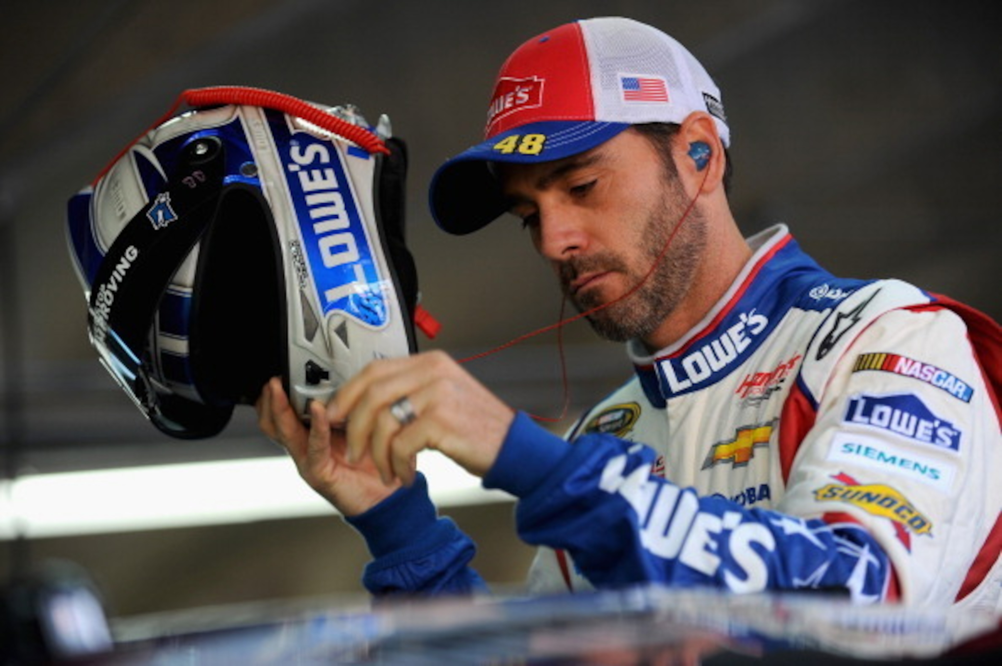 CHARLOTTE, NC - MAY 24: Jimmie Johnson, driver of the #48 Lowe's Patriotic Chevrolet, stands in the garage area during practice for the NASCAR Sprint Cup Series Coca-Cola 600 at Charlotte Motor Speedway on May 24, 2014 in Charlotte, North Carolina. (Phot CHARLOTTE, NC - MAY 24: Jimmie Johnson, driver of the #48 Lowe's Patriotic Chevrolet, stands in the garage area during practice for the NASCAR Sprint Cup Series Coca-Cola 600 at Charlotte Motor Speedway on May 24, 2014 in Charlotte, North Carolina. (Phot