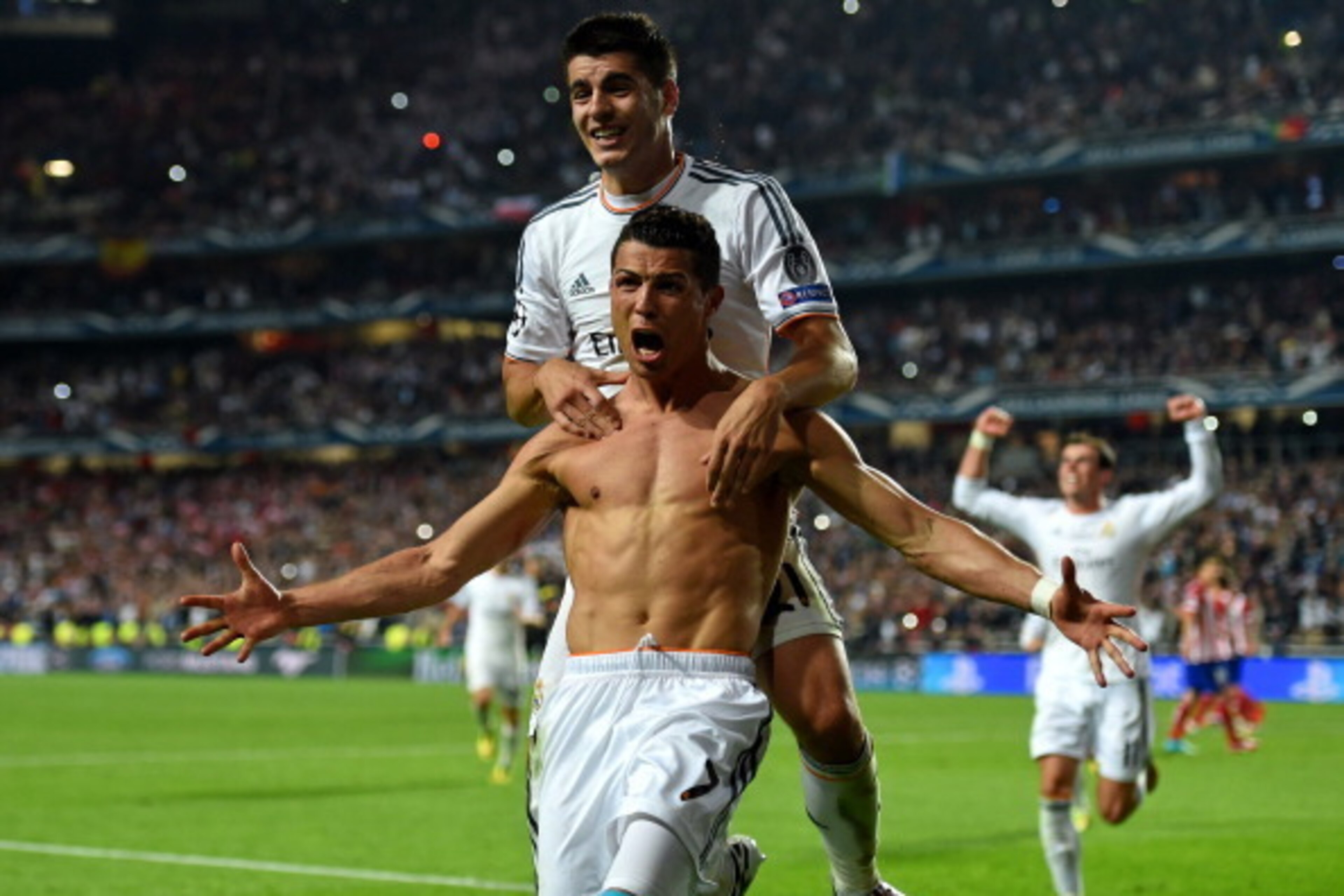 LISBON, PORTUGAL - MAY 24:  Cristiano Ronaldo of Real Madrid celebrates with r21 after scoring their fourth goal from the penalty spot during the UEFA Champions League Final between Real Madrid and Atletico de Madrid at Estadio da Luz on May 24, 2014 in L