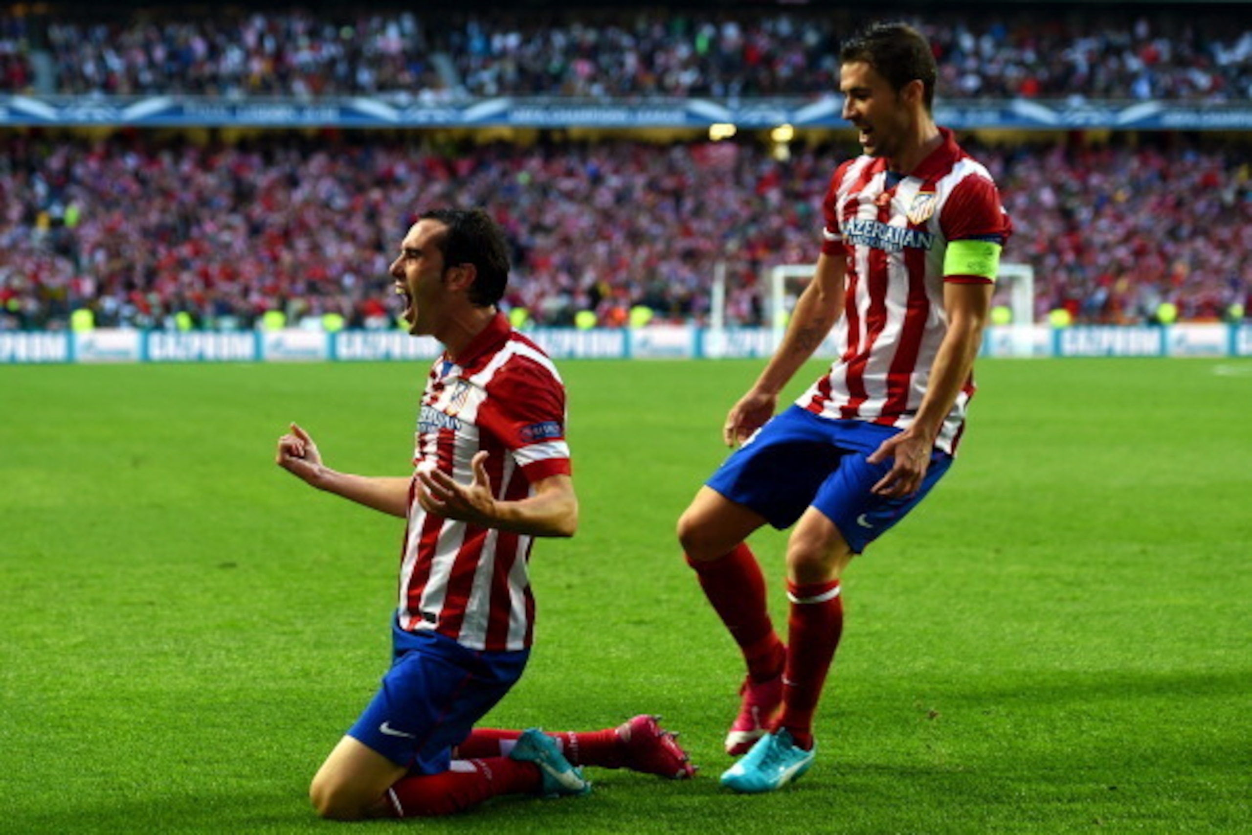 LISBON, PORTUGAL - MAY 24:  Diego Godin of Club Atletico de Madrid celebrates scoring the opening goal with Gabi of Club Atletico de Madrid during the UEFA Champions League Final between Real Madrid and Atletico de Madrid at Estadio da Luz on May 24, 2014
