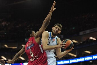 LONDON, ENGLAND - MAY 12:  Nikola Mirotic of Real Madrid tussles with Kyle Hines of Olympiacos Piraeus during the Turkish Airlines EuroLeague Final Four final between Olympiacos Piraeus and Real Madrid at the O2 Arena on May 12, 2013 in London, England.  