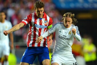 LISBON, PORTUGAL - MAY 24:  Gabi of Club Atletico de Madrid puts Luka Modric of Real Madrid under pressure during the UEFA Champions League Final between Real Madrid and Atletico de Madrid at Estadio da Luz on May 24, 2014 in Lisbon, Portugal.  (Photo by