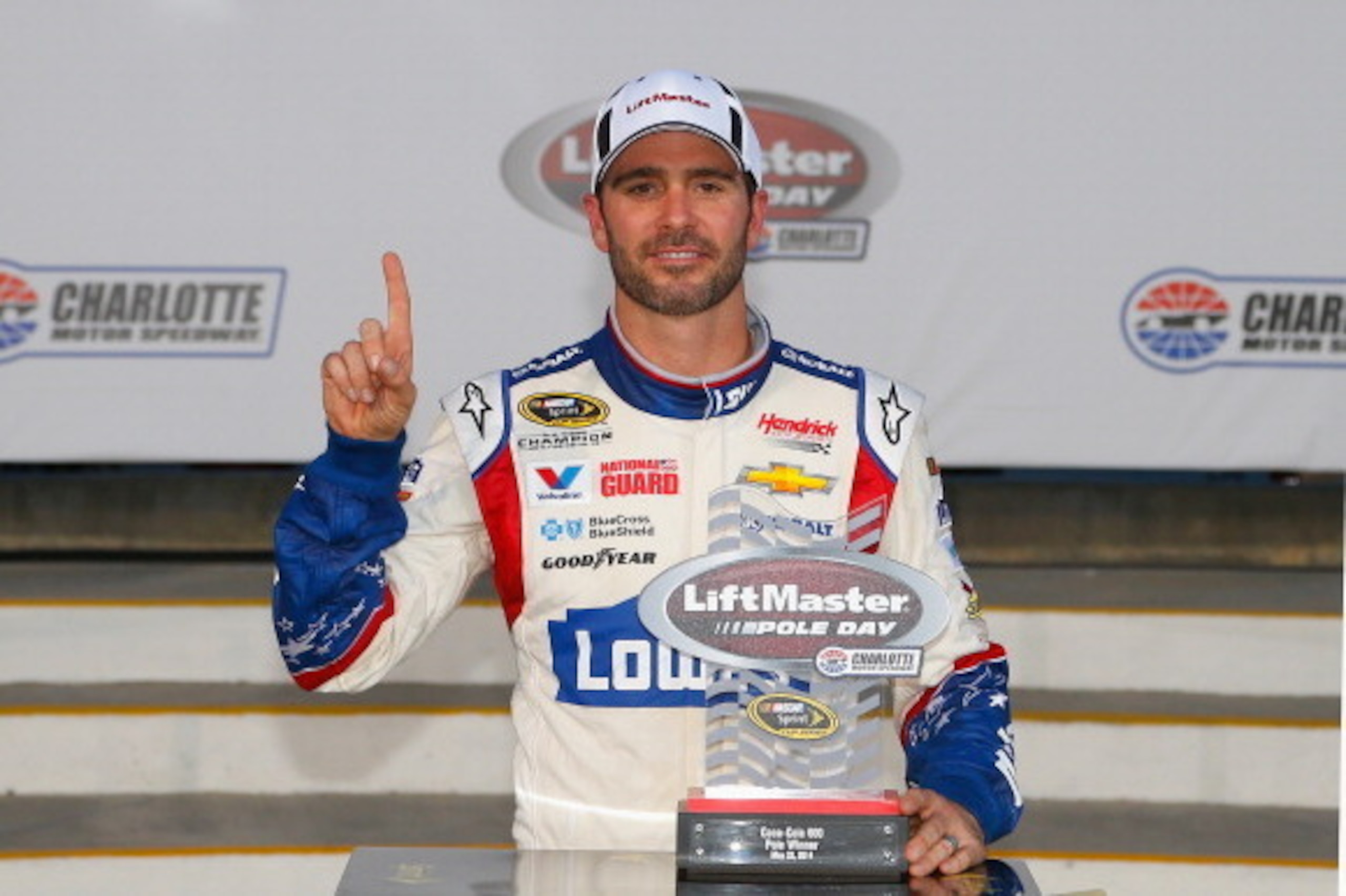 CHARLOTTE, NC - MAY 22:  Jimmie Johnson, driver of the #48 Lowe's Patriotic Chevrolet, celebrates after qualifying for the pole position for the NASCAR Sprint Cup Series Coca-Cola 600 at Charlotte Motor Speedway on May 22, 2014 in Charlotte, North Carolin