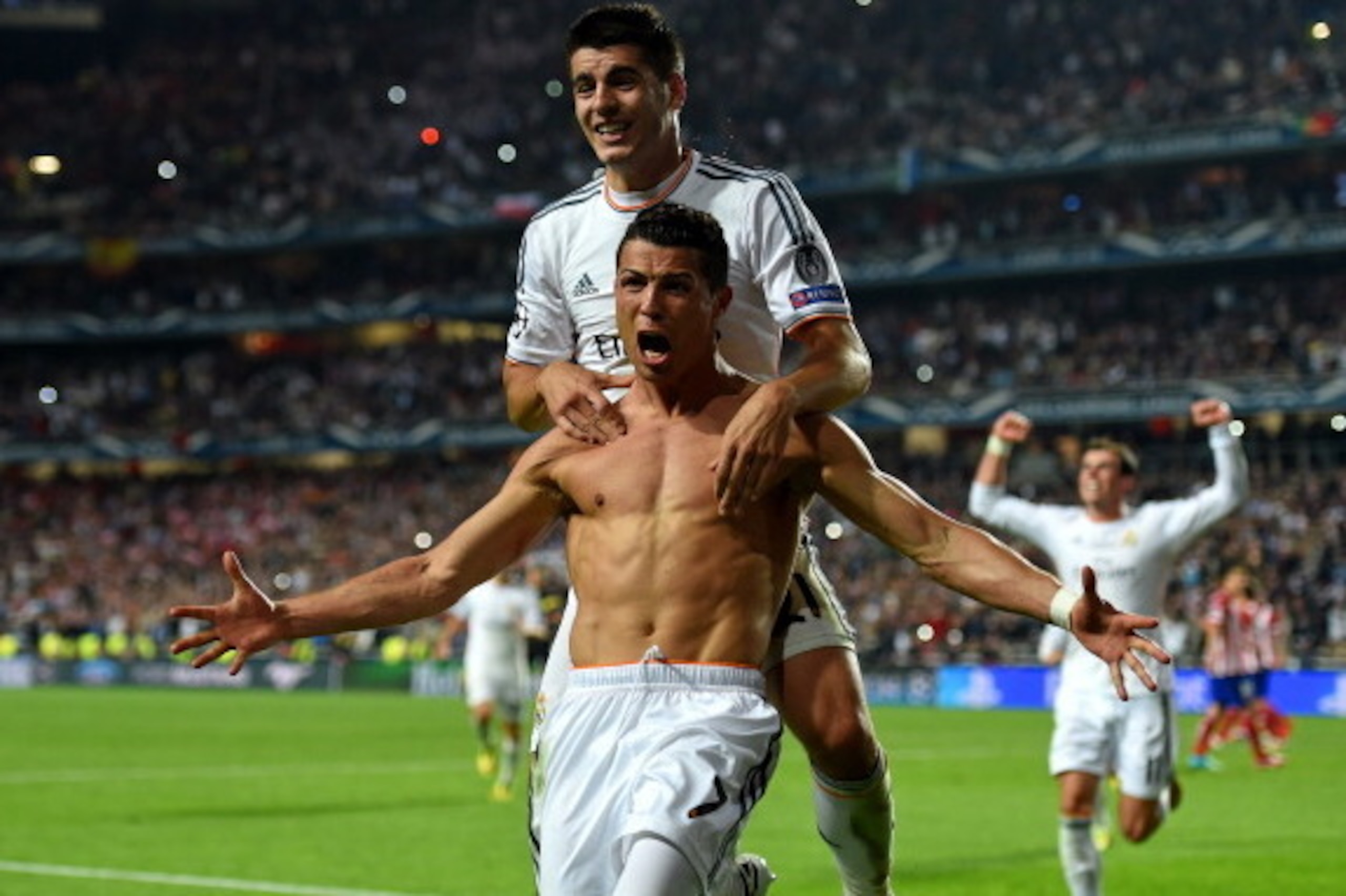 LISBON, PORTUGAL - MAY 24:  Cristiano Ronaldo of Real Madrid celebrates with r21 after scoring their fourth goal from the penalty spot during the UEFA Champions League Final between Real Madrid and Atletico de Madrid at Estadio da Luz on May 24, 2014 in L