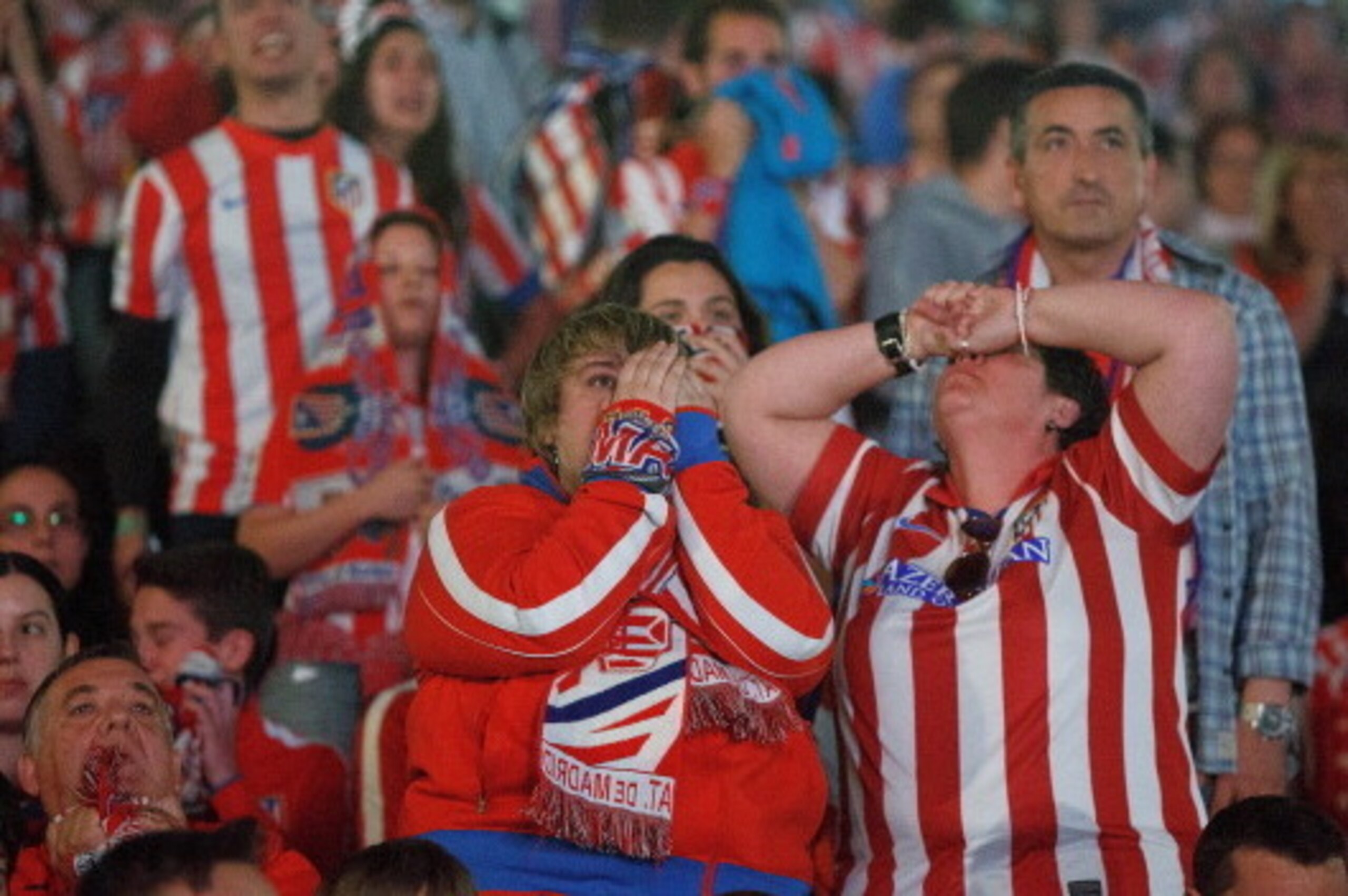 MADRID, SPAIN - MAY 24: Atletico de Madrid fans react after Real Madrid's goal during the UEFA Champions League Final match between Real Madrid CF and Club Atletico de Madrid on May 24, 2014 in Madrid, Spain. More than 85,000 Santiago Bernabeu seats have MADRID, SPAIN - MAY 24: Atletico de Madrid fans react after Real Madrid's goal during the UEFA Champions League Final match between Real Madrid CF and Club Atletico de Madrid on May 24, 2014 in Madrid, Spain. More than 85,000 Santiago Bernabeu seats have