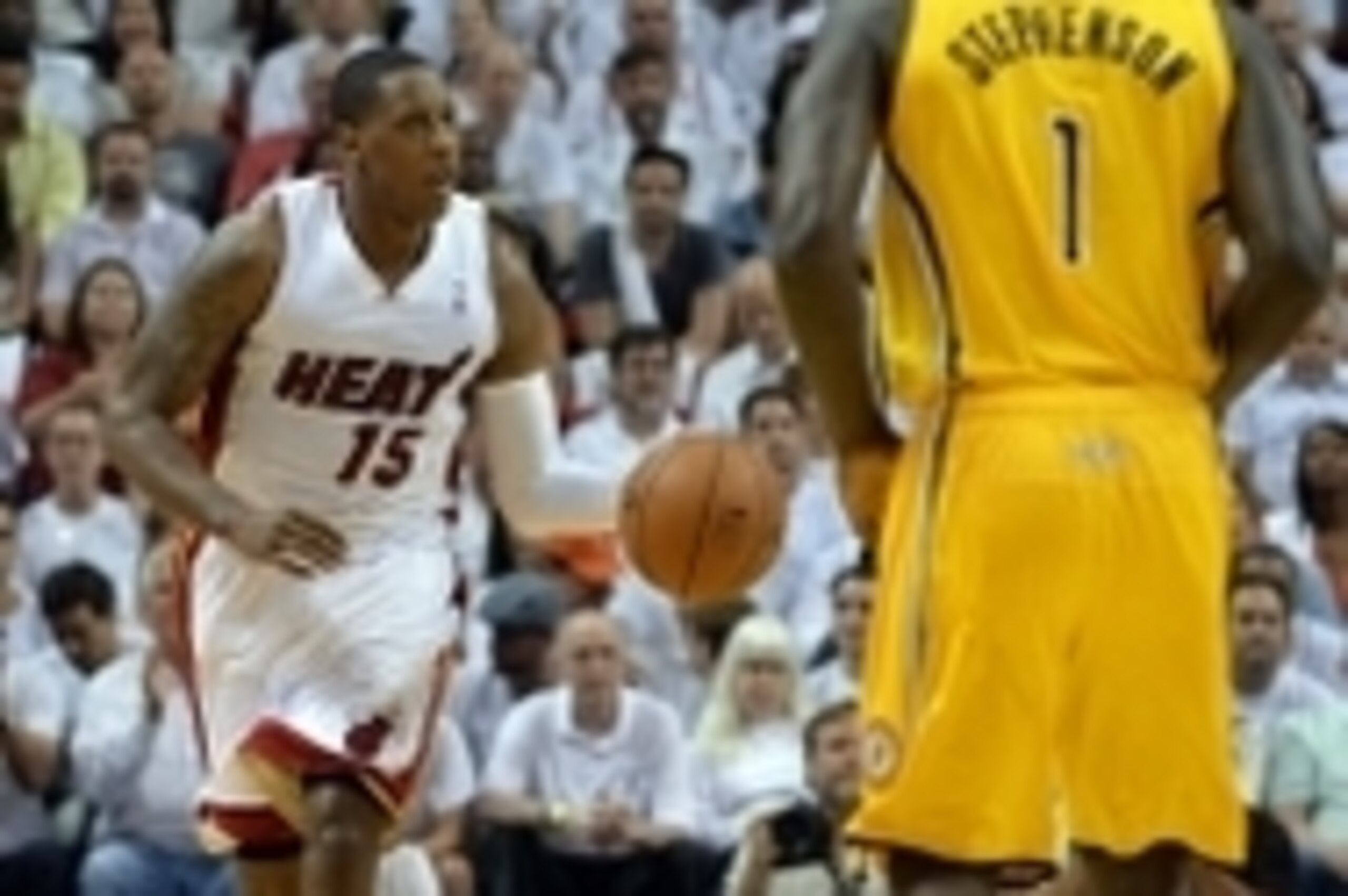 May 24, 2014; Miami, FL, USA; Miami Heat guard Mario Chalmers (15) moves the ball up the court against Indiana Pacers guard Lance Stephenson (1) in game three of the Eastern Conference Finals of the 2014 NBA Playoffs at American Airlines Arena. Mandatory 