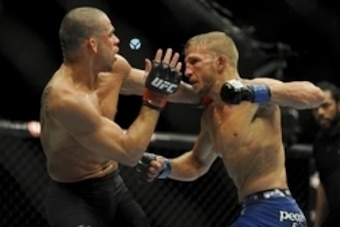 May 24, 2014; Las Vegas, NV, USA;   TJ Dillashaw (blue) throws a punch at  Renan Barao (red) during their UFC 173 bantamweight championship bout at MGM Grand Garden Arena. Dillashaw won the bout by way of TKO. Mandatory Credit: Stephen R. Sylvanie-USA TOD