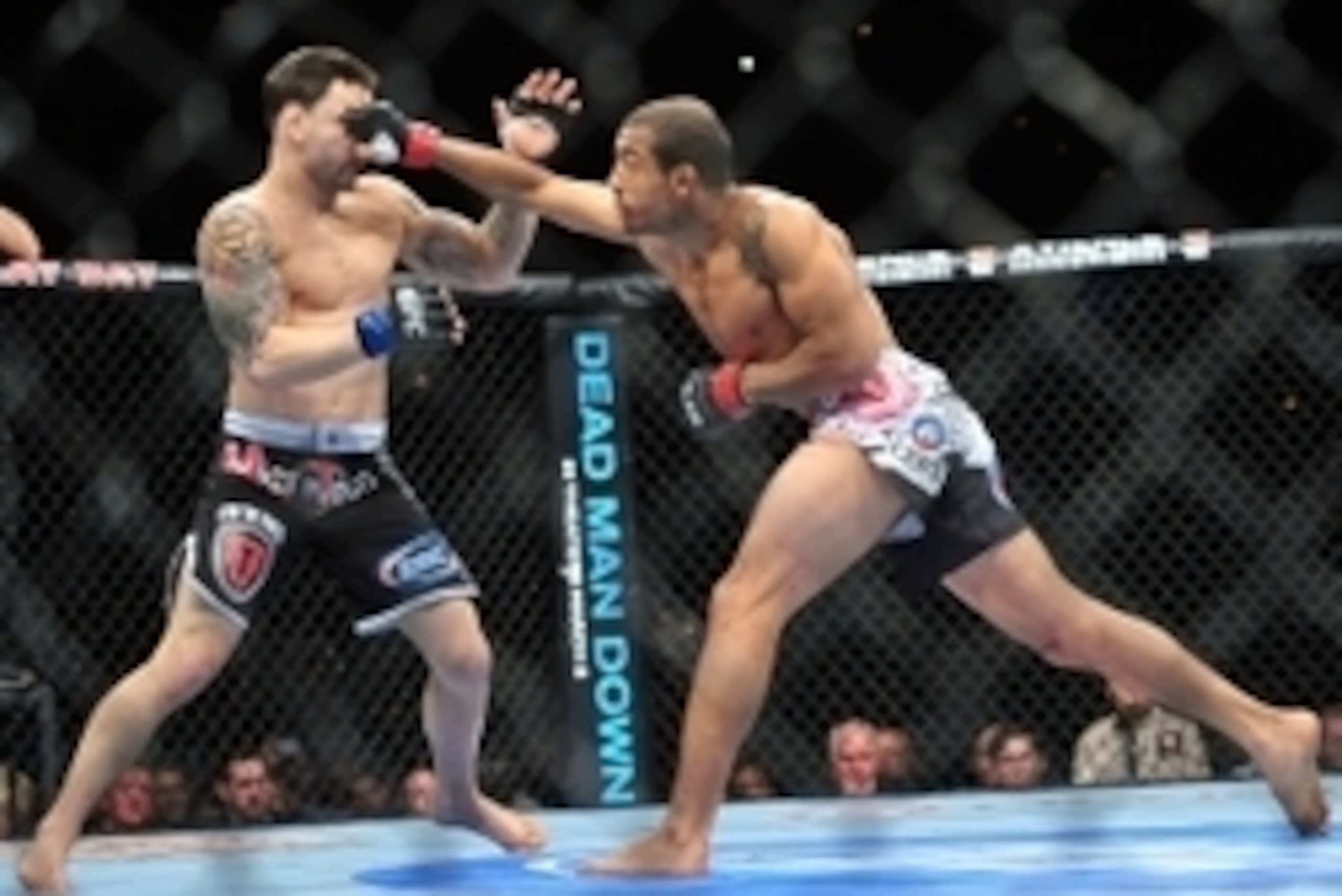 Feb 2, 2013; Las Vegas, NV, USA; Jose Aldo (right) lands a straight right to Frankie Edgar (left) during UFC 156 at the Mandalay Bay Events Center. Mandatory Credit: Gary A. Vasquez-USA TODAY Sports