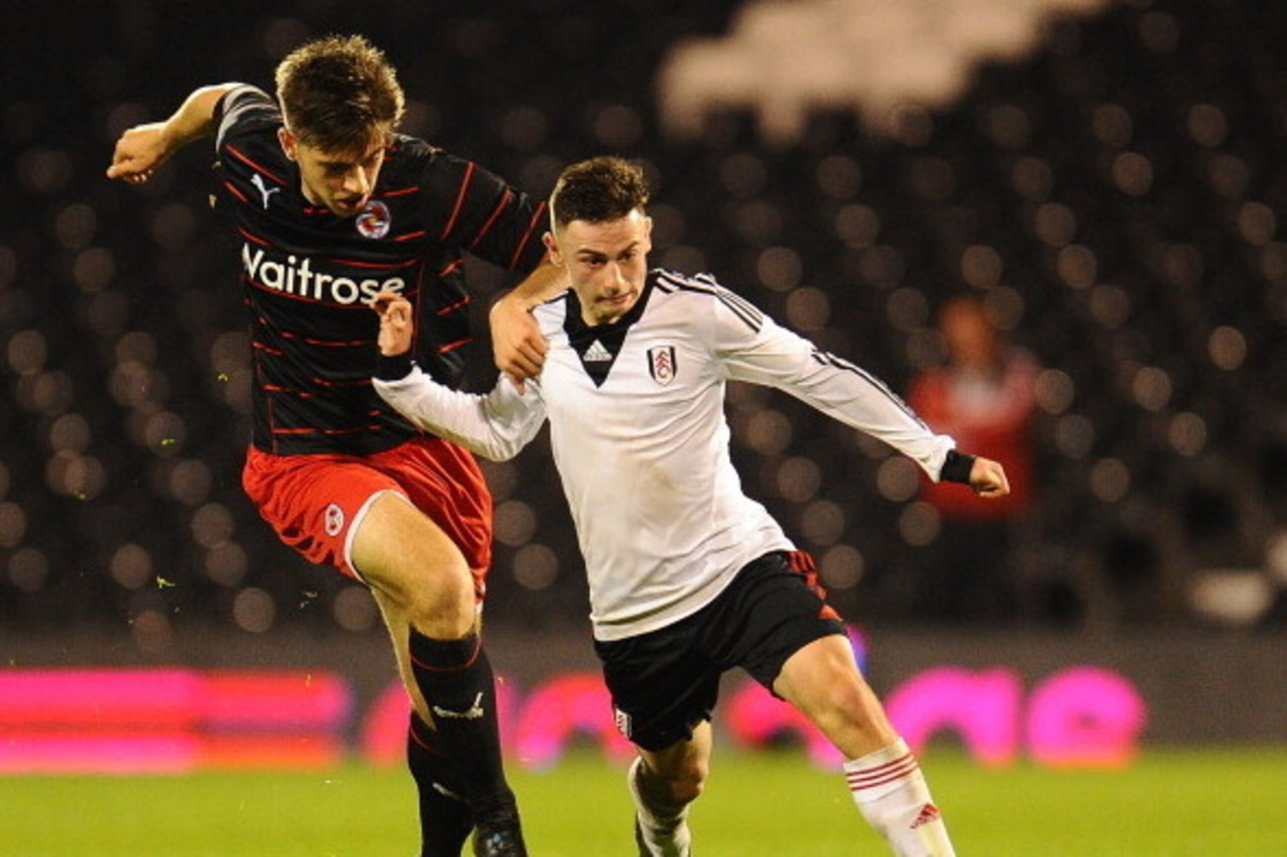 LONDON, ENGLAND - APRIL 07: Patrick Roberts of Fulham U18 and Harry Cardwell of Reading U18 chase the ball during the FA Youth Cup Semi Final second leg match at Craven Cottage on April 7, 2014 in London, England. (Photo by Tom Dulat/Getty Images)
