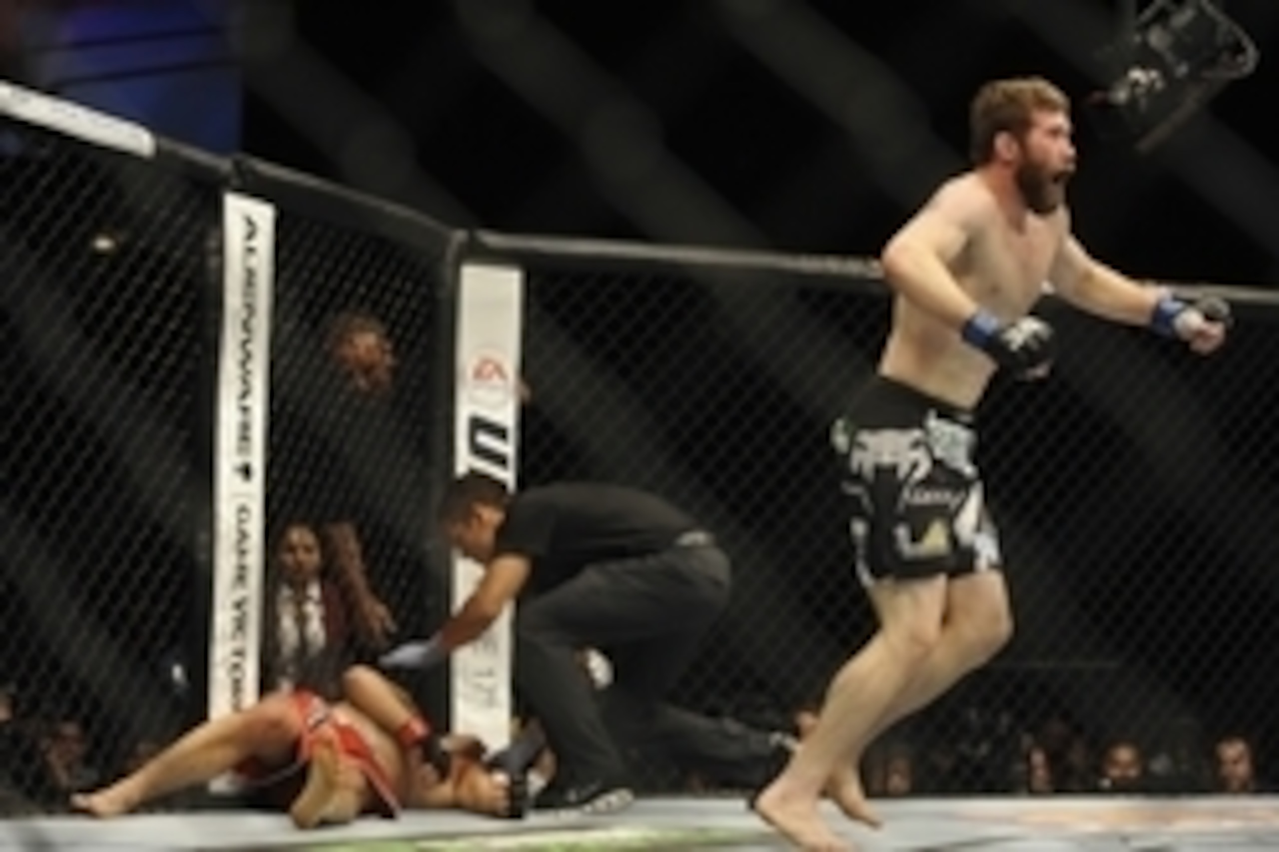 May 24, 2014; Las Vegas, NV, USA;Al Laquinta (red) recovers after tapping out as his opponent Mitch Clarke (blue) celebrates during their UFC 173 lightweight bout at MGM Grand Garden Arena. Clarke won his bout by submission. Mandatory Credit: Stephen R. S